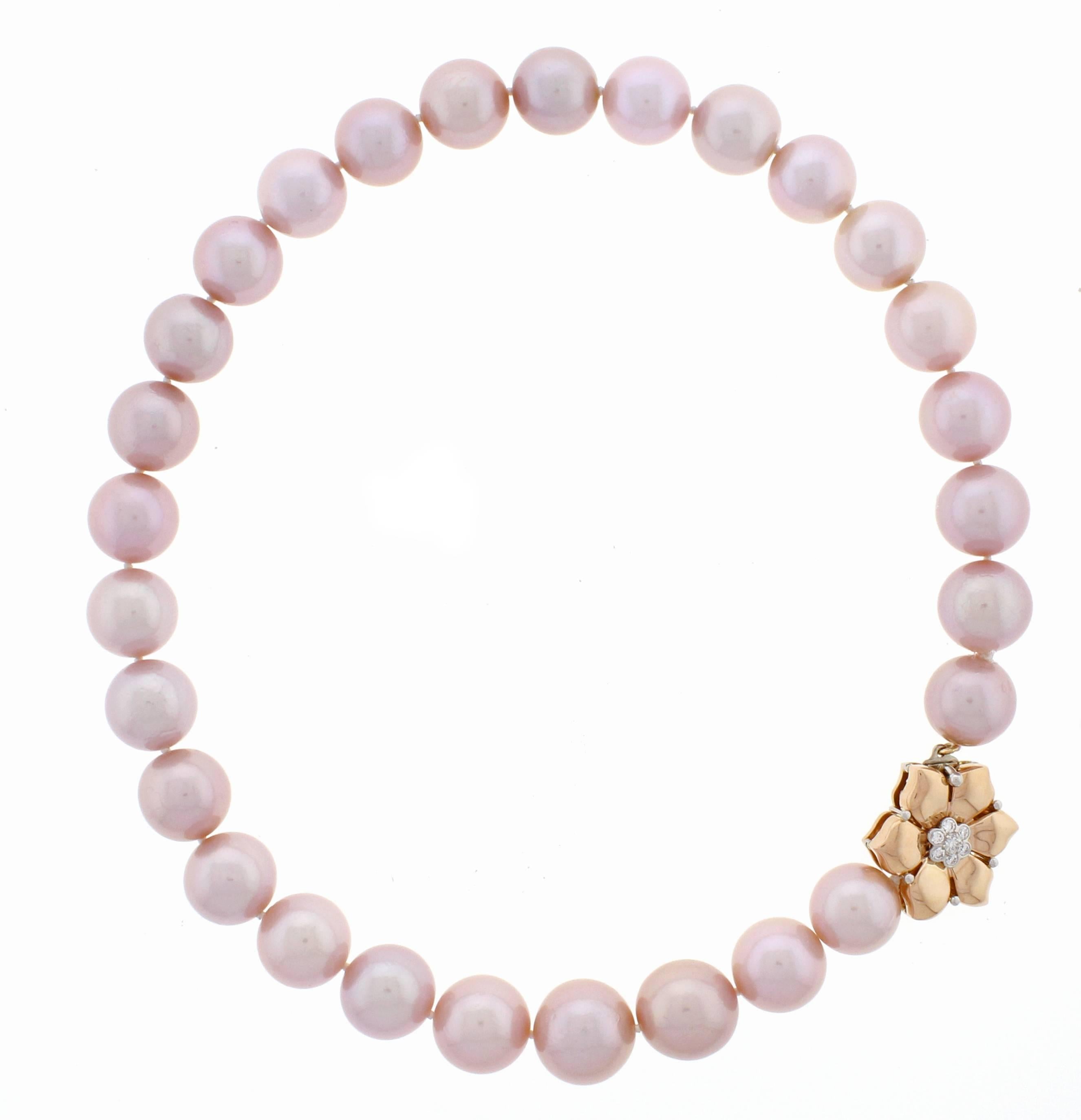 These magnificent natural color pink fresh water pearls graduate from 16-14mm.  The pink gold and platinum clasp is highlighted by .35 carats of diamonds. Pearl of this natural color and size are quite rare with only a limited number of strands