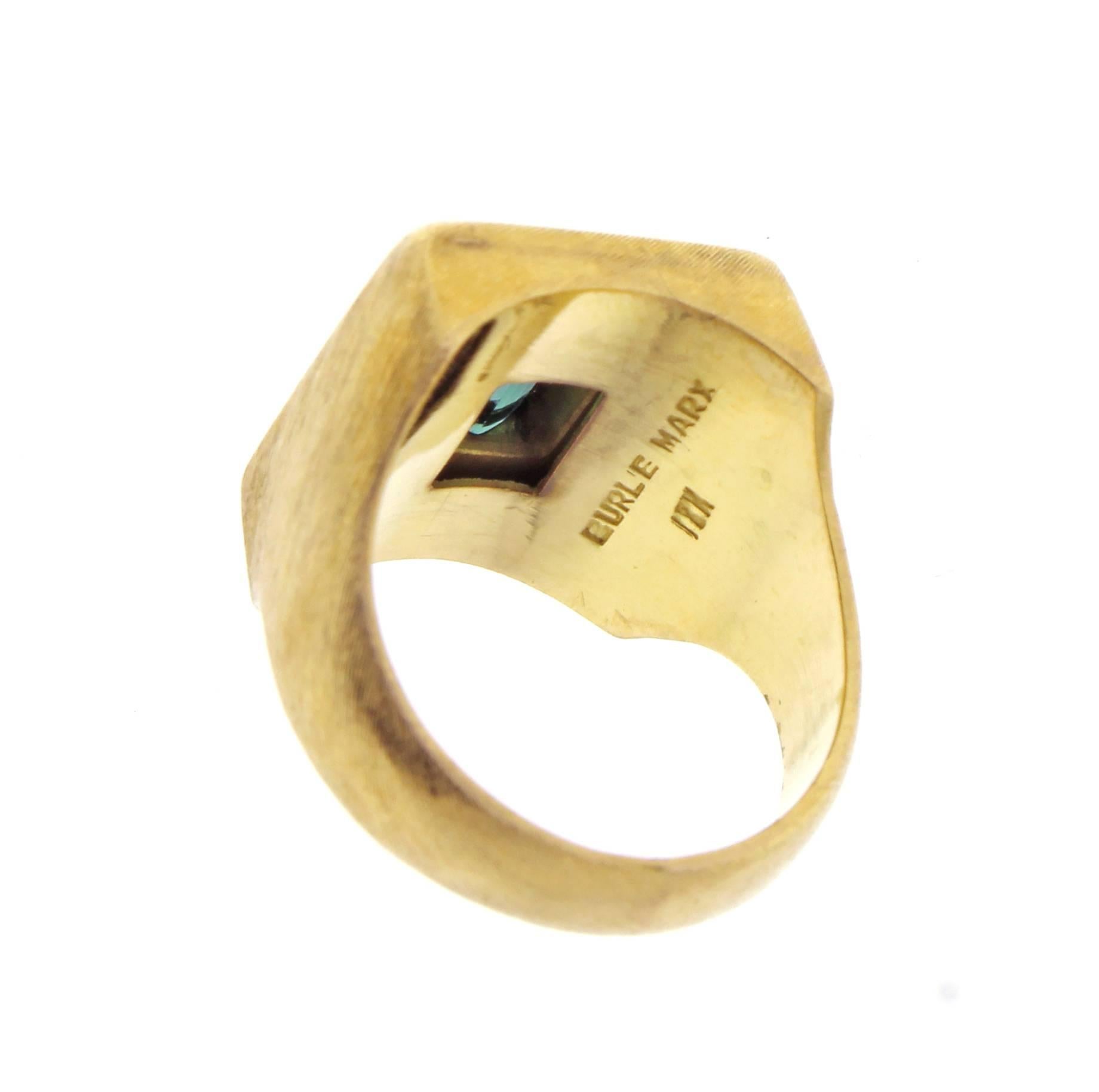 Emerald cut green tourmaline ring by world renowned Brazilian jeweler Haroldo Burle Marx (1911-1991). The ring features a bezel 13*11mm green tourmaline a brushed 18 karat gold setting. Size 7 adjustable. Over all ring dimension 17*15mm