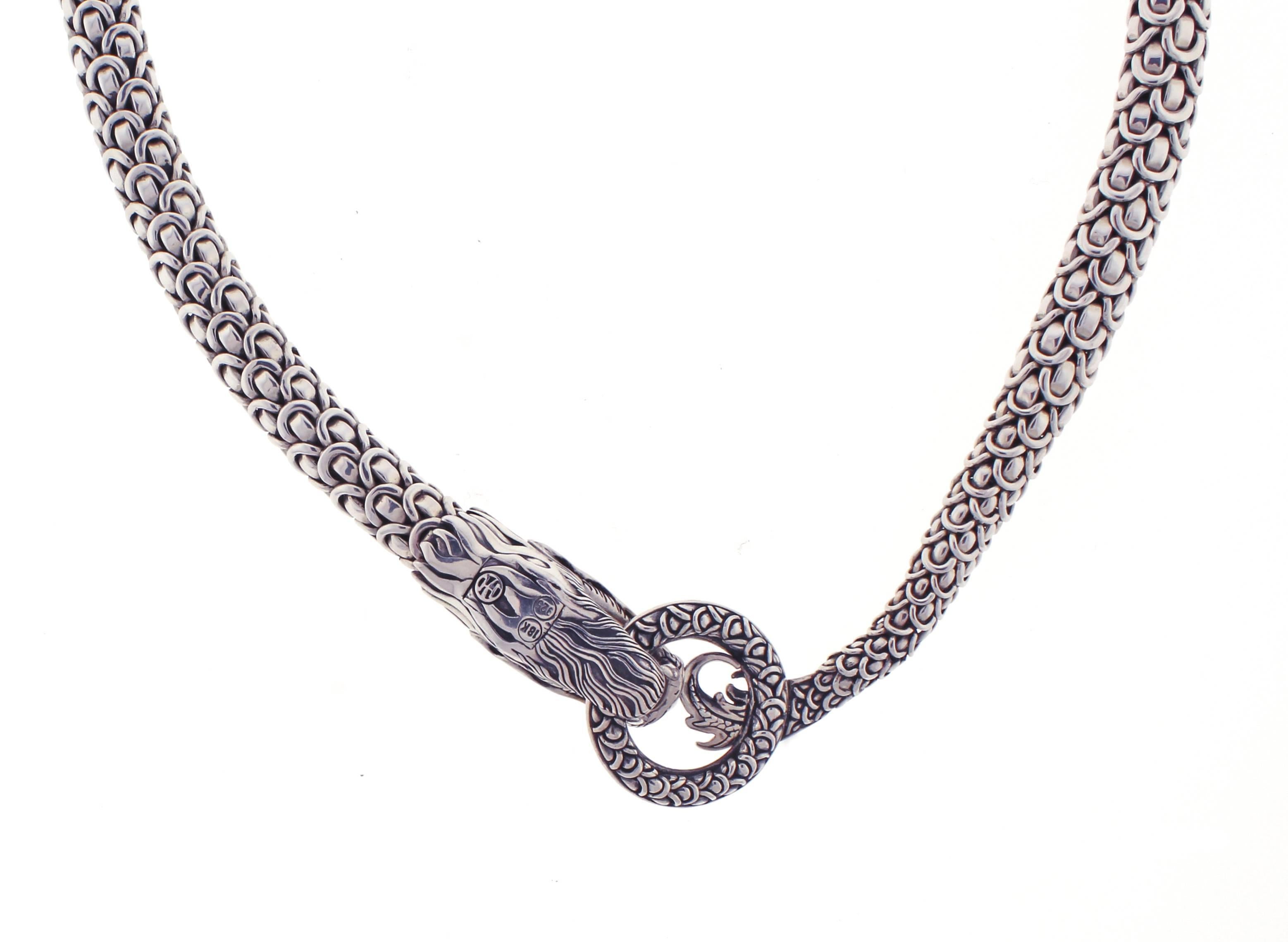 Amazing Naga dragon from John Hardy's Naga collection.
Intricately made out of sterling silver, this necklace features a dragon's head at one end of the 
dragon mail chain while his fiery tail rests at the other end. 
They loop around and meet at a