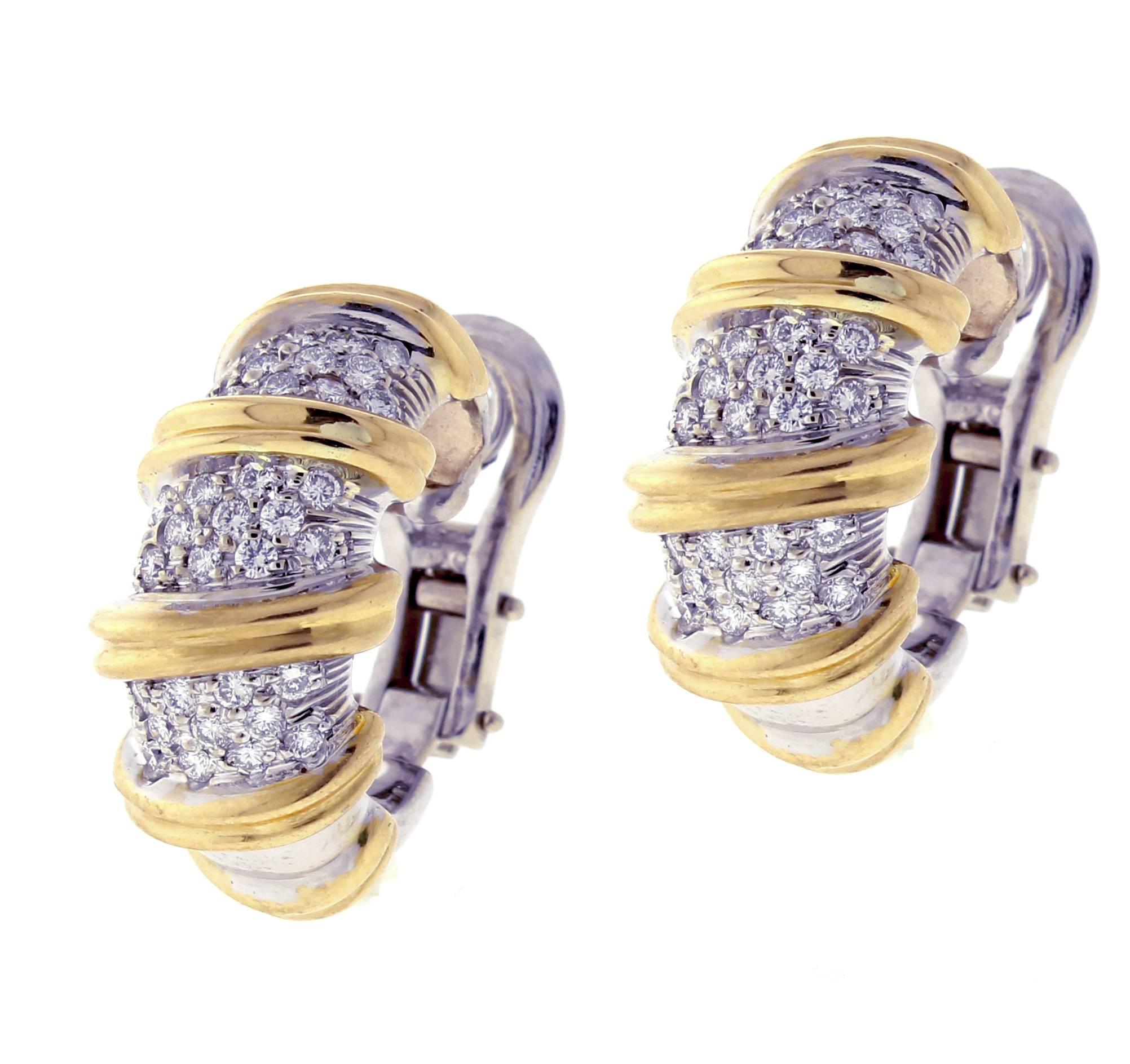 From Italian designer Roberto Coin’s Nabucco collection, a pair of 18 karat white and yellow gold  diamond earrings. The earrings feature 66 brilliant diamonds weighing approximately 1.40 carat. The earrings are 10.7mm wide and 25mm high.