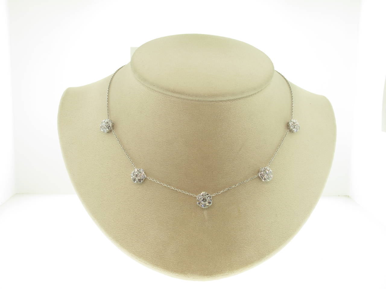 This Van Cleef & Arpels Fleurette necklace contains 5 diamond flowers. It is the large model.  The necklace is made in 18 karat white gold with round diamonds; diamond quality D-E, IF-VVS. There are 35 prong-set diamonds in the necklace with a total