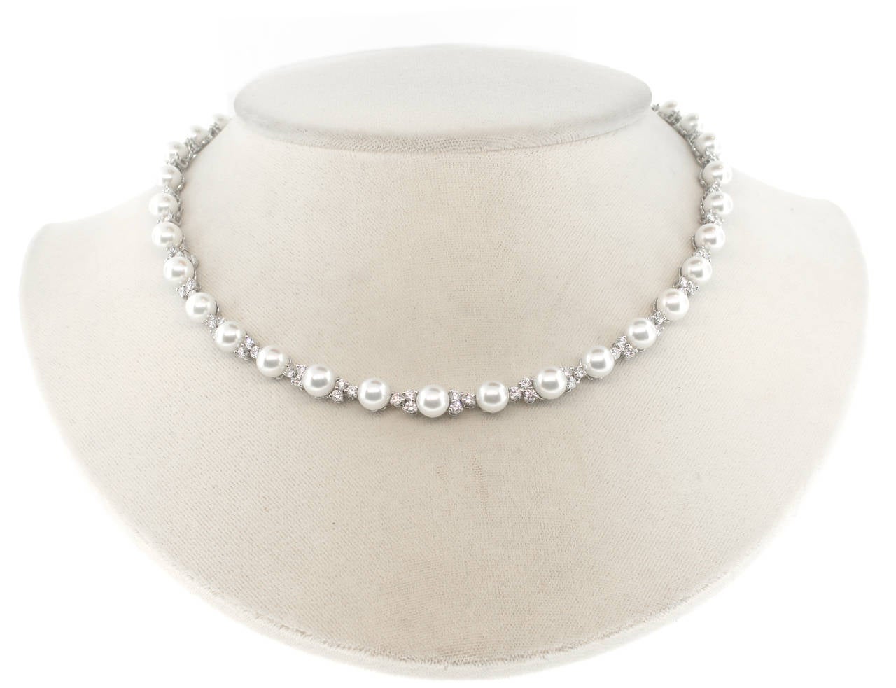 Three brilliant diamonds set in perfect harmony. A necklace of thirty-six  6.5-7 mm Akoya cultured pearls and 108 round brilliant diamonds weighing 4.91 carats.  Set platinum. 16