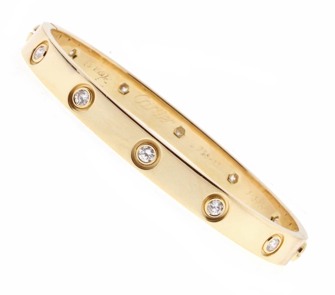 18 karat yellow gold Cartier Love bracelet, set with 10 Diamond weighing one carat.  The love bracelet remains an iconic symbol of love that transcends convention. Original screw design   Size 17