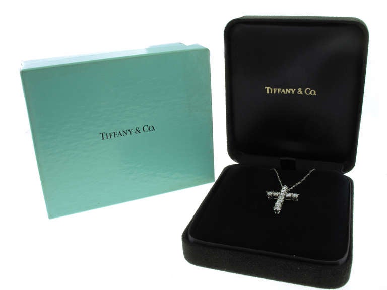 This Tiffany & Co. diamond cross necklace is in platinum and features 11 diamonds with a total weight of 1.75 carats. The cross measures 1 inch in length by .75 of an inch in width.