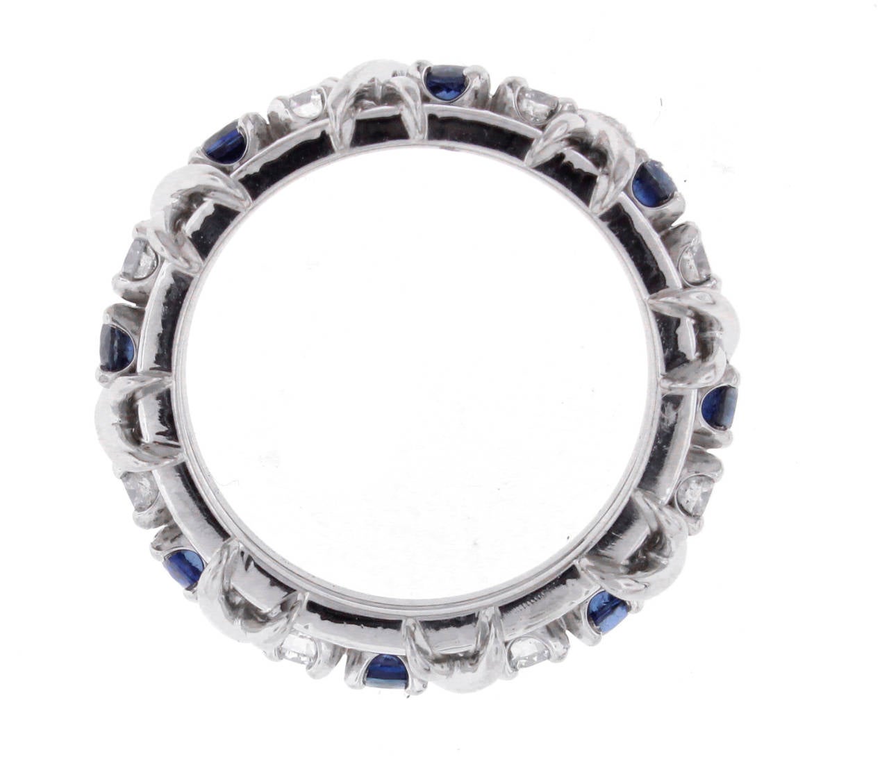This iconic 16-stone Tiffany & Co. band ring was designed by Jean Schlumberger and features the classic X motif with 8 sapphires weighing .75 and 8 diamonds weighing .59 carats. Set in platinum, size 6 1/2