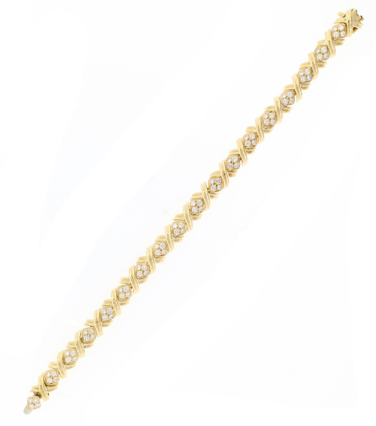 18 Karat yellow gold diamond signature X bracelet with 75 diamonds weighing 2.25 carat. The diamonds are G color and VVS clarity. 7 1/4 inches. Signed Tiffany & Co.