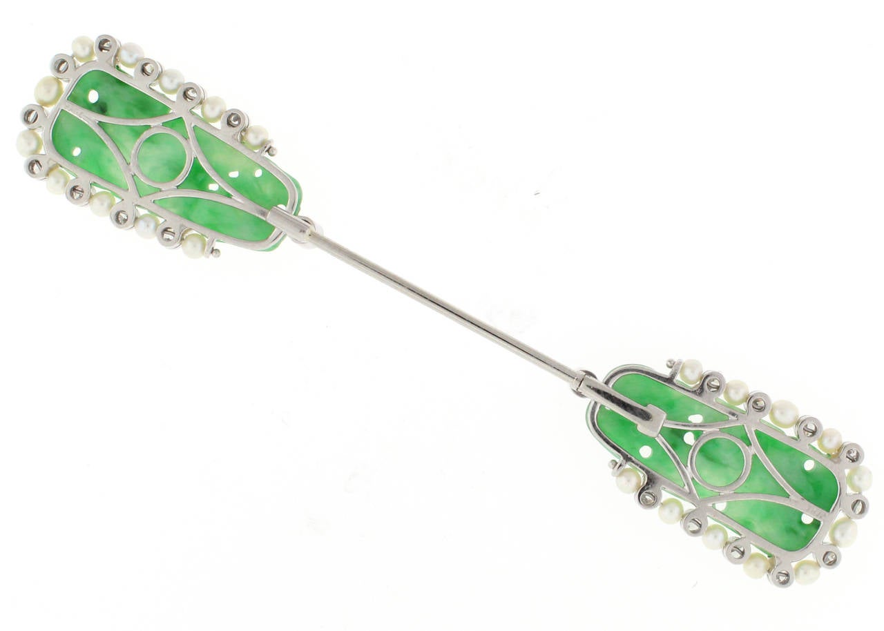 This Raymond Yard Jade Jabot Pin is made in platinum and contains .90 carats of diamonds that accent the beautiful jade. This pin is Art Deco and measures 3.75 inches in length and just under .75 of an inch in width at the widest point.