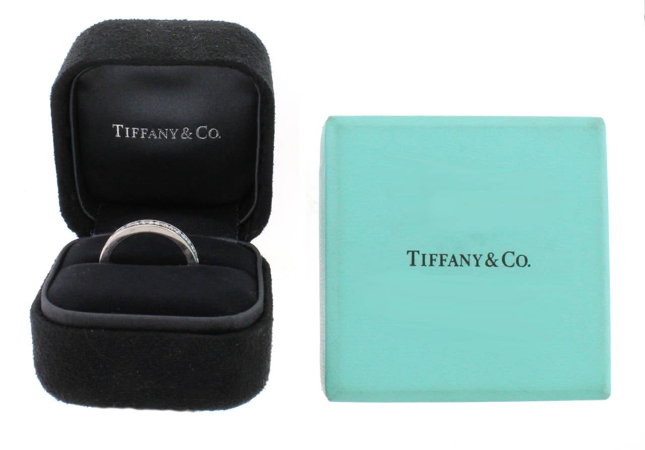 This Tiffany & Co. Channel Set Diamond Band contains 1.80 carats of round brilliant diamonds (22 diamonds total). They are set in platinum. This ring is a size 7 and CANNOT be sized.