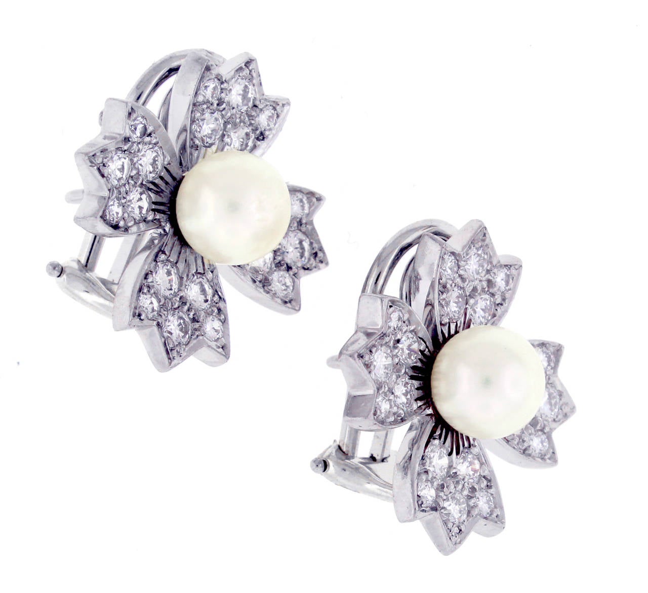 Wonderful Tiffany and Co diamond and pearl flower earrings.  Forty brilliant cut diamonds and two cultured 61/2mm cultured pearls make a statement of harmony and elegance. Set in platinum
