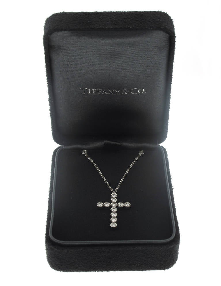 This stunning Tiffany & Co. diamond Cross pendant is set in platinum and features 21 diamonds weighing 1.26 carats.  The diamonds are all bezel set. The chain contains 10 bezel set diamonds and measures 16 inches in length. The cross measures 1