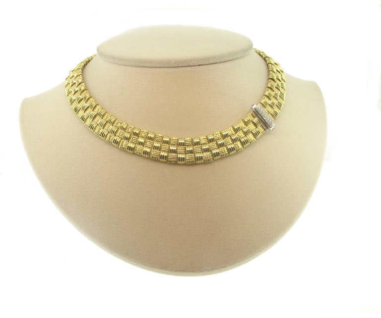 This beautiful  triple row Appasionata necklace by Roberto Coin is 18 karat yellow gold. The basket weave chain measures 15 millimeters in width. The necklace is 14 inches in length. The clasp features .22 carats of diamonds.