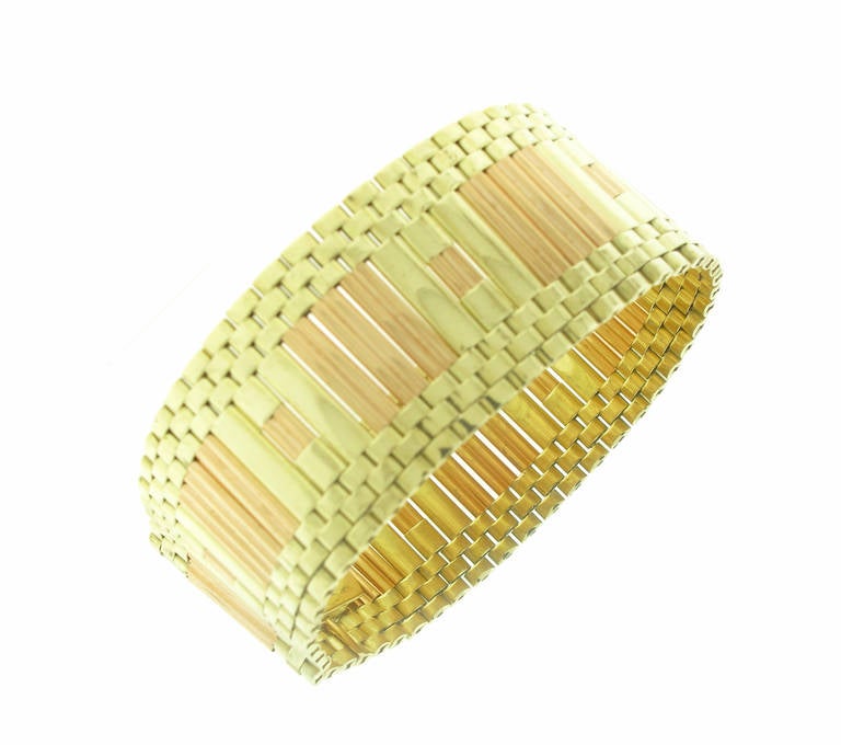 This antique Tiffany & Co. bracelet features a stunning 14 karat rose gold and yellow gold pattern. The bracelet is wide and measures 1 inch in width and 7.5 inches in length. The bracelet weighs 61.3 grams.