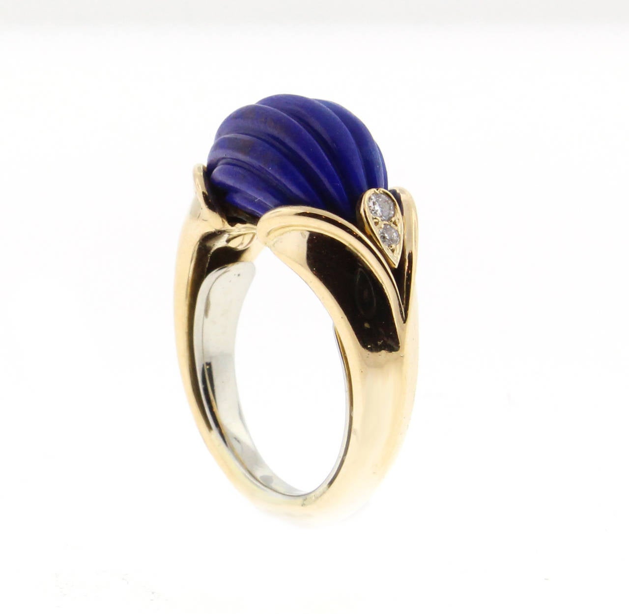 From Van Cleef and Arpels this carved lapis and diamond ring. The ring features a beautifully carved lapis resting in an elegant setting. The ring has an expandable butterfly guard size 5.12, may be adjusted.