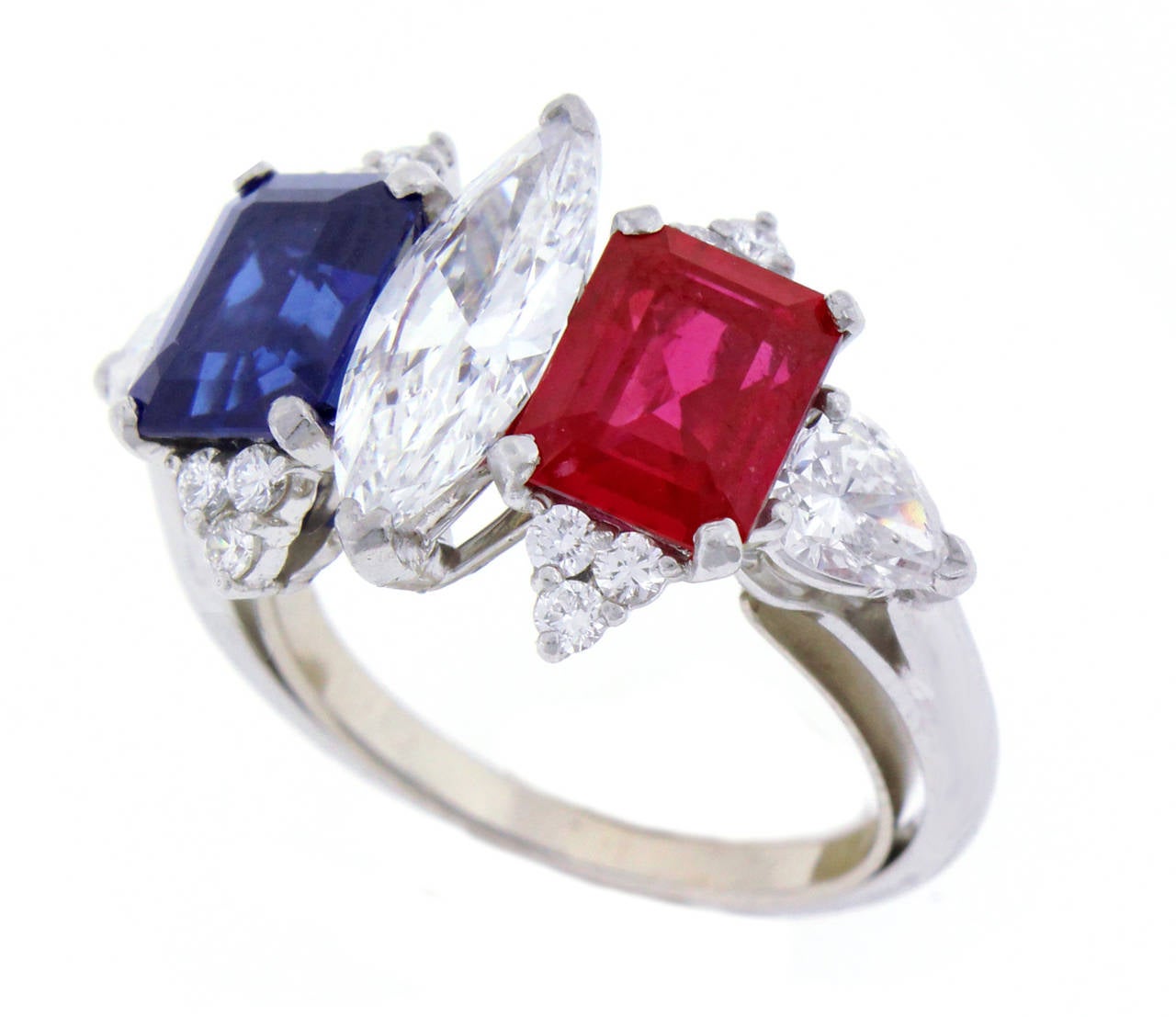 This magnificent ring features a center marquise diamond weighing 1.05 carats. The diamond is  D color and VVS clarity.

The Ruby weighs 1.71 carats and is un-heated from Burma. The ruby is crystalline and exceeding fine.

The Sapphire weighs