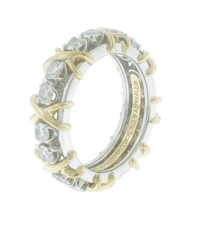 Jean Schlumberger’s rendition of an “X,” the popular symbol of love. The ring is  in 18k gold with round brilliant diamonds set  in platinum. 16 Dia=1.18  Size 5 1/2... This ring is new, originally purchased  February 2014 and never worn.