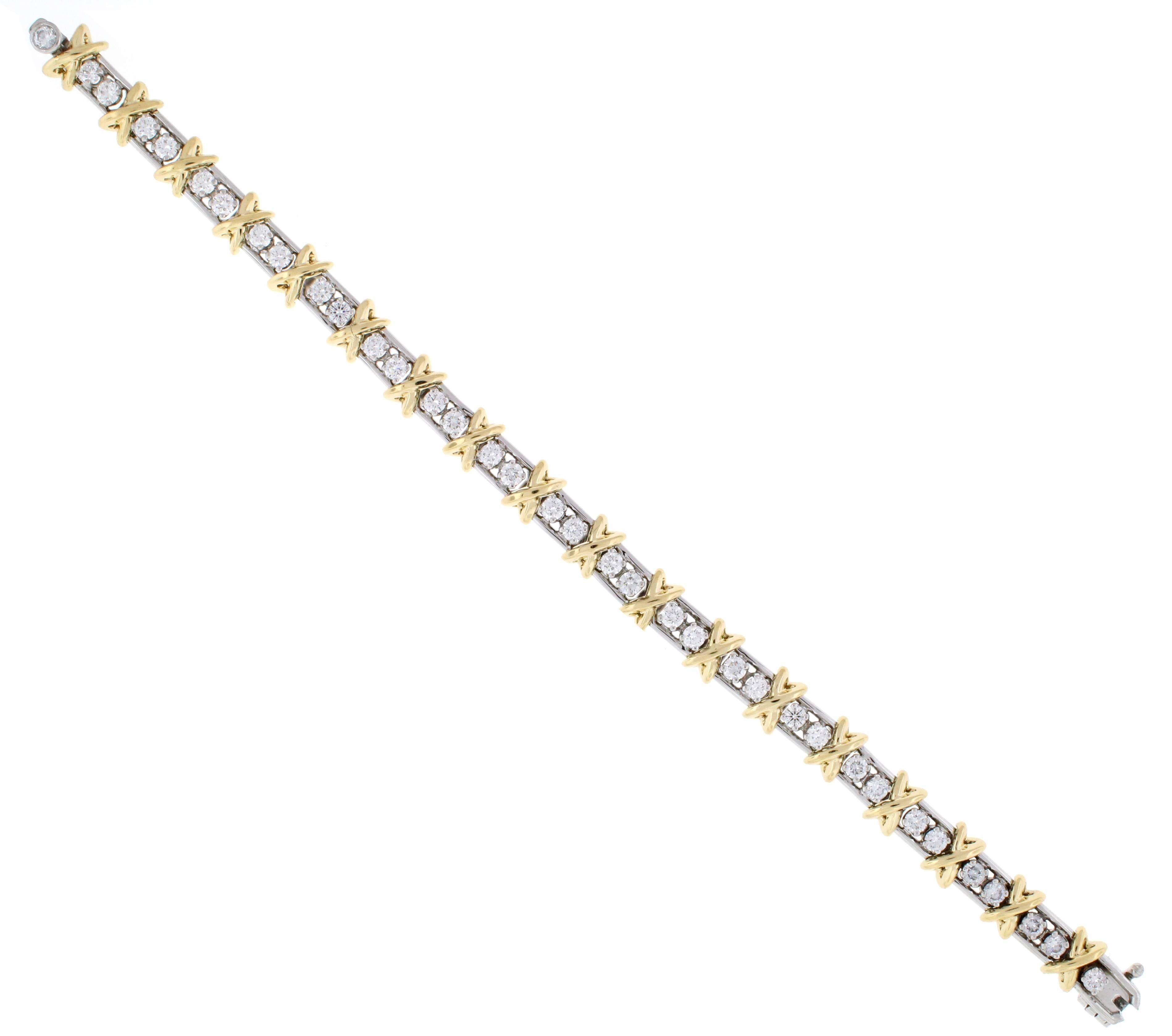 Jean Schlumberger’s rendition of an “X,” the popular symbol of love. The bracelet is in platinum and 18 karat yellow gold with 36 round brilliant diamonds weighing 3.00 carats. Diamonds are F color and VVS clarity. The bracelet is in excellent