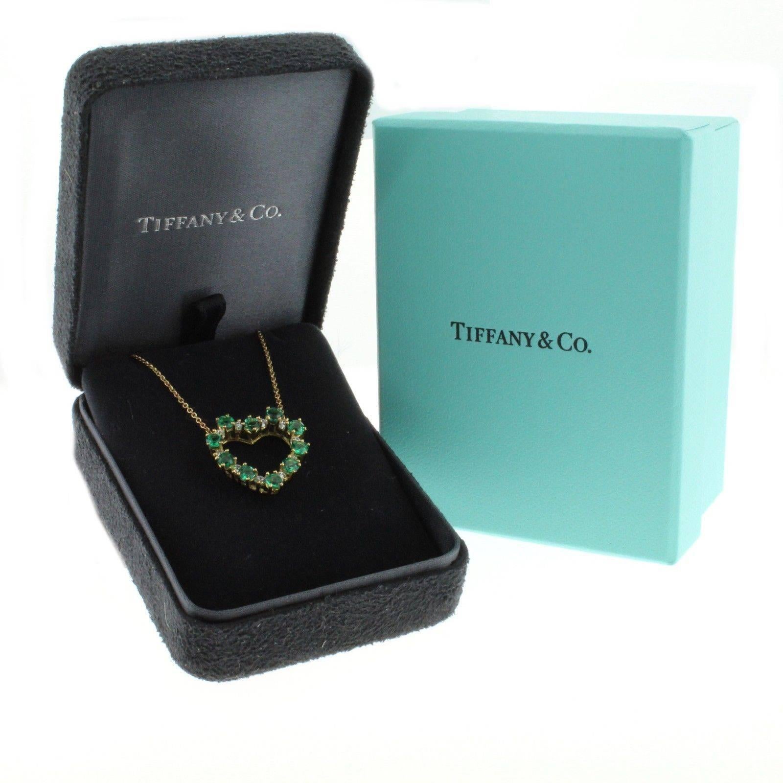 18kt gold emerald and diamond Tiffany heart pendant comprised of  ten round emeralds weighing 1 carats and 10 round diamond weighing .30cts, 16 inch necklace