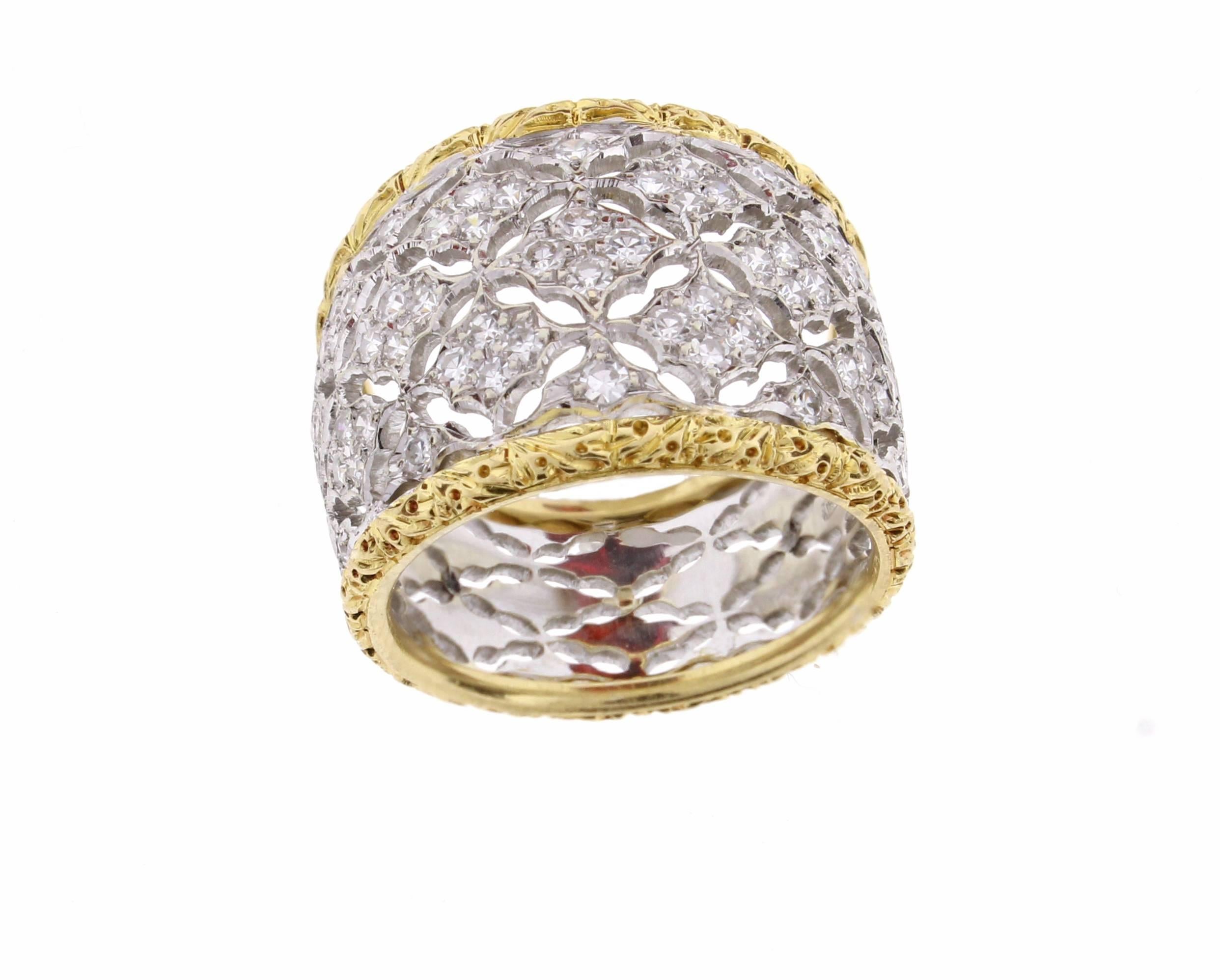  Federico Buccellati ring in 18 Karat yellow and white gold. 
This wide diamond ring features white gold filigree set with sixty two brilliant cut diamonds weighing .60 carats edged with yellow gold filigree. The ring tapers from 16mm to 10mm 8.4