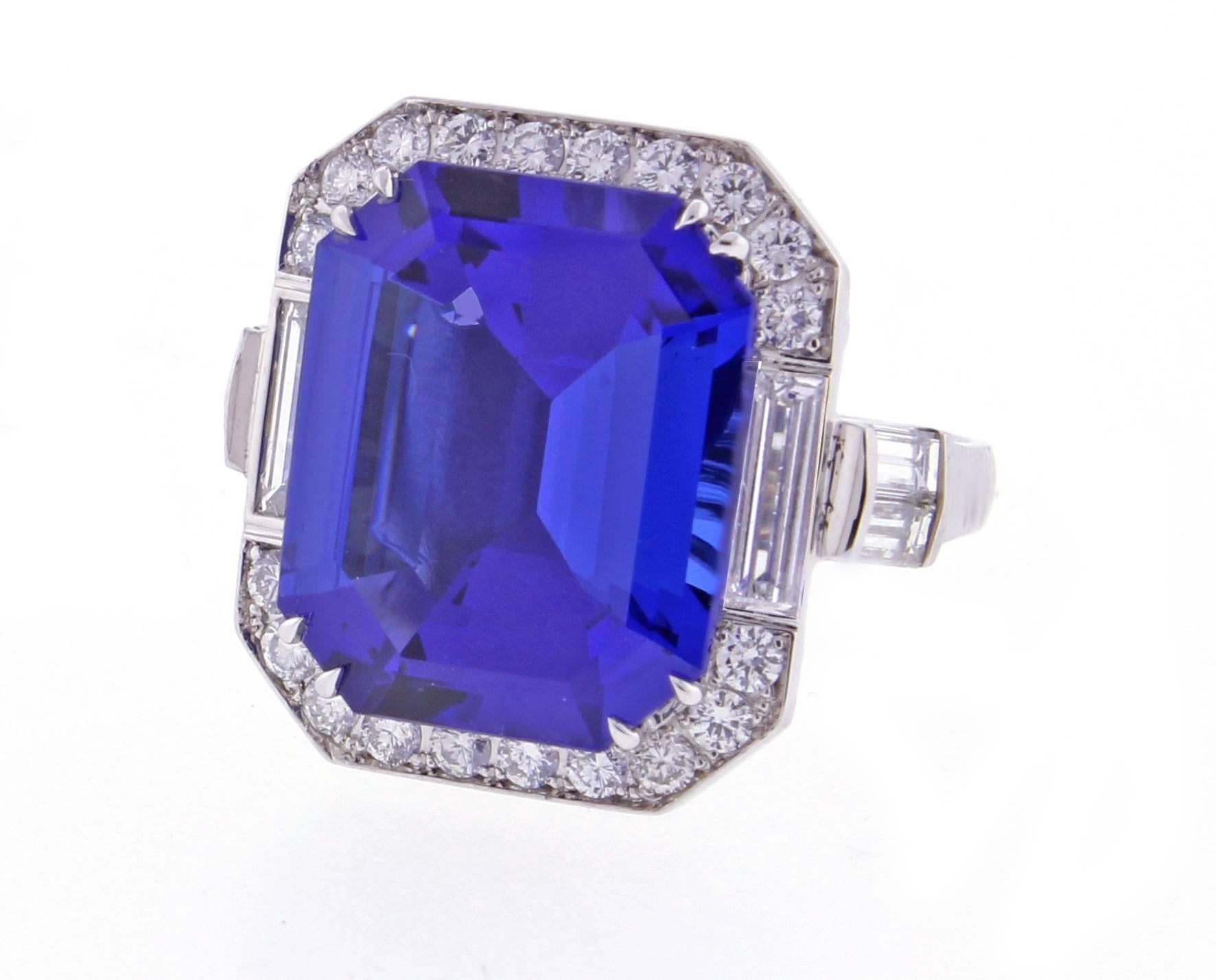From the master ring makers of Pampillonia Jewelers, a Tanzanite and diamond handmade platinum ring. The emerald cut  rich violet blue Tanzanite weights 12.03. There are .51 carats of round diamonds and .89 carats of baguette diamonds. This ring is
