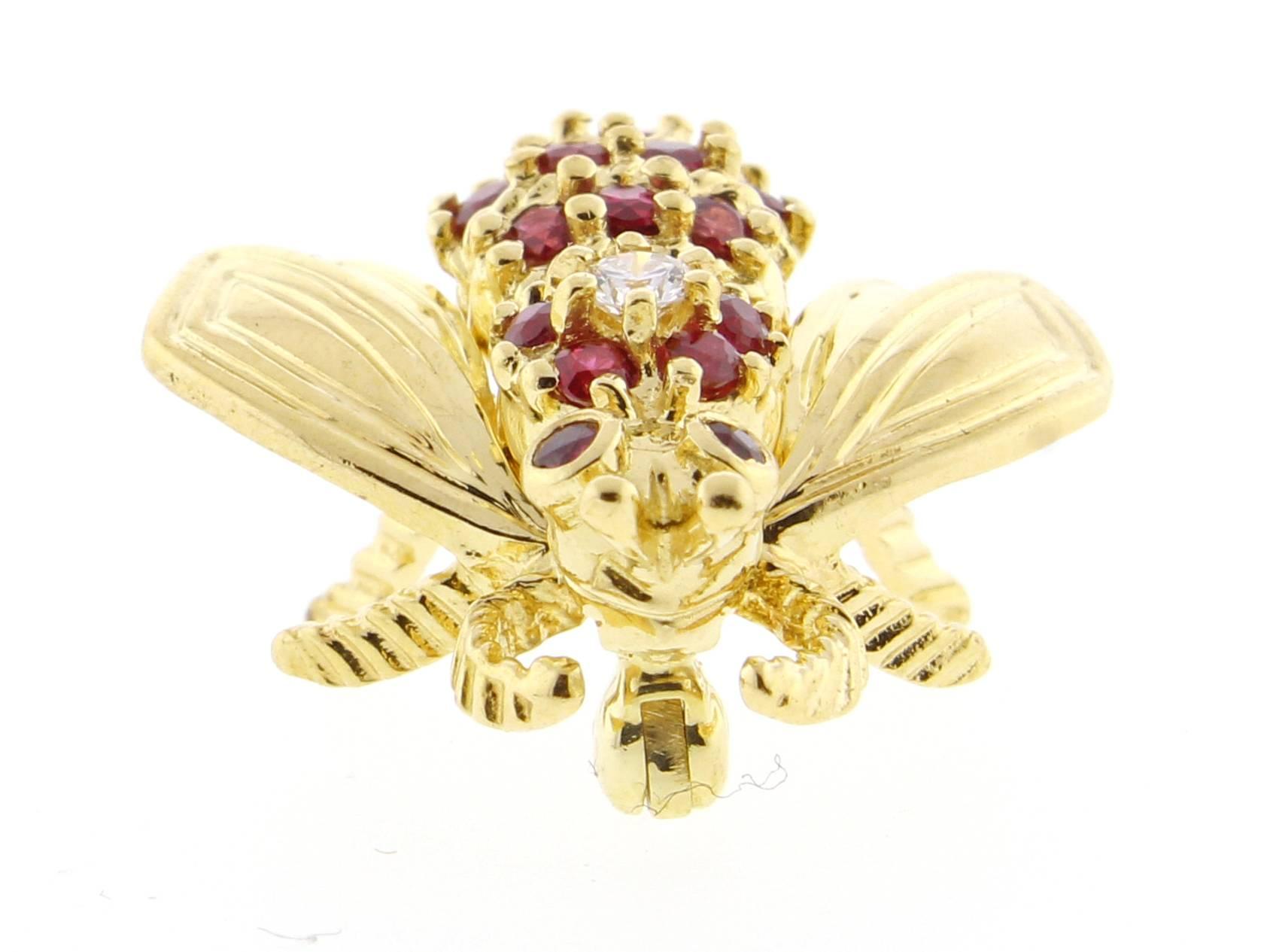 Tiffany & Co.'s rendition of the  bumble bee. Set with 18 rubies weighing .60 carats and a brilliant diamond weighing .06 carat.s this whimsical creation gives style and pizazz to any outfit.  Set in 18 karat gold, 3/4 of and inch