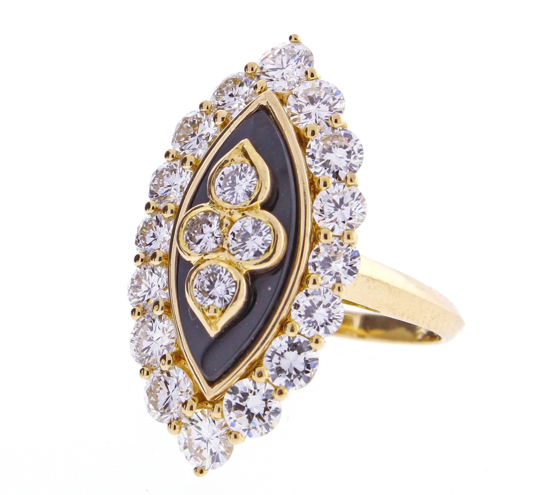 This highly collectable vintage diamond and black onyx navette shape boast twenty brilliant diamonds weighing approximately 2.50 carats, set in 18 karat gold. Signed VCA for Van Cleef & Arpels and numbered 5K89.4 with French hallmarks. The ring