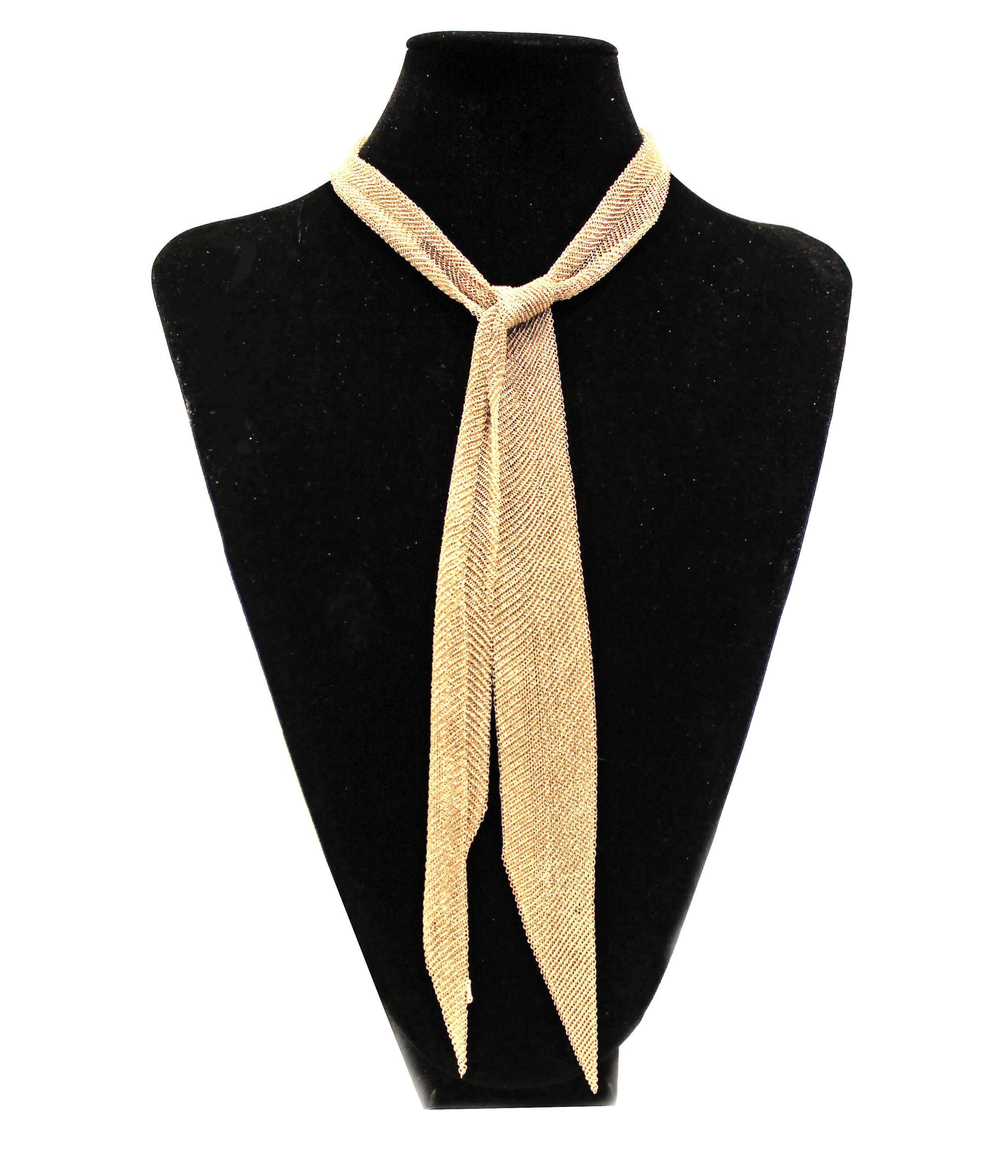The form is malleable and ergonomic in the way it drapes over the body's contours. Scarf necklace in 18k yellow gold. 38