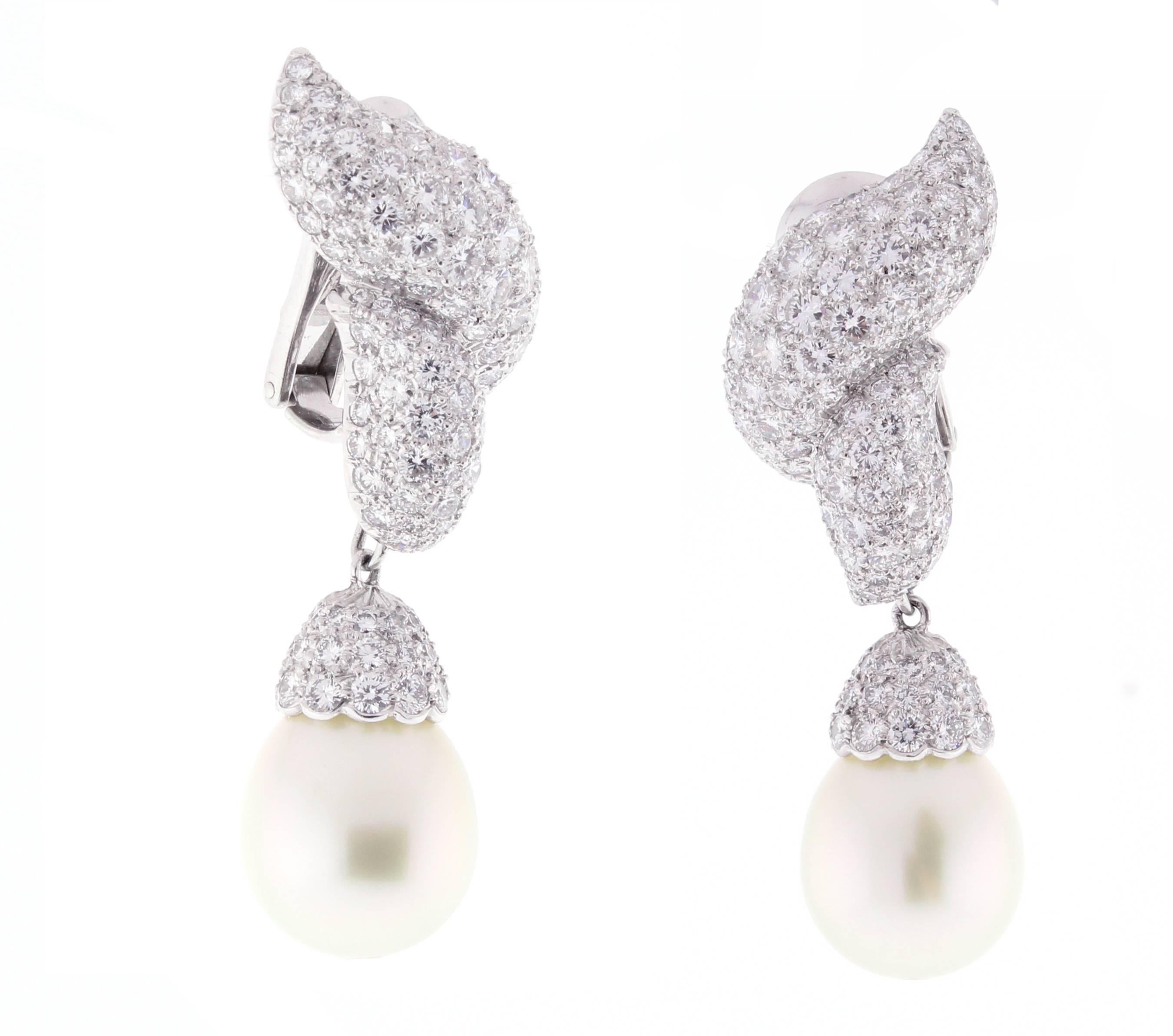 A dramatic pearl drop earring featuring 14 X13mm and 7 ¾ carats of shimmering brilliant diamonds, set in platinum. The earring boast  184 brilliant diamonds weighing approximately  6 carats. The drops are comprised of 66 diamonds weighing 1.74 carats