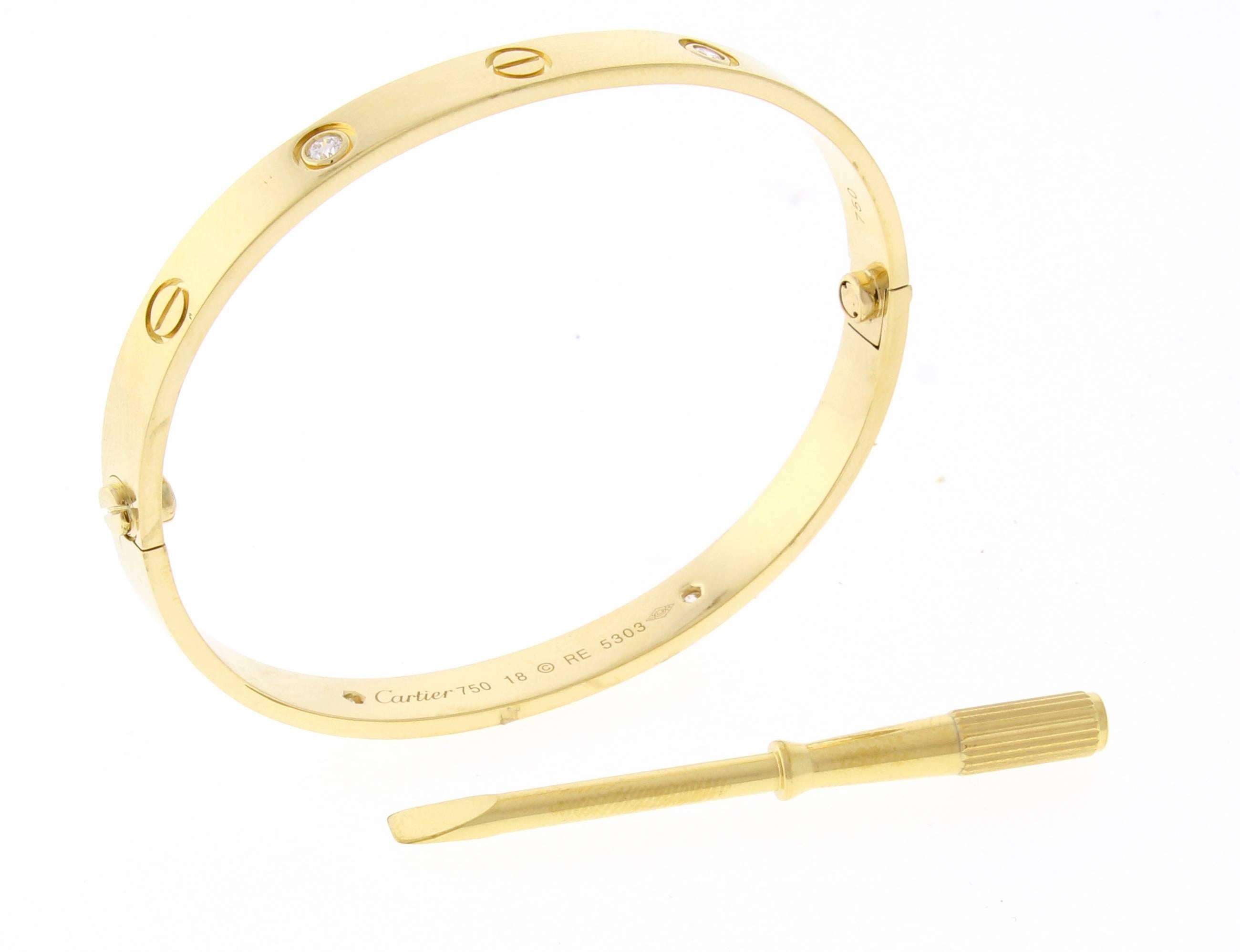 18 karat yellow gold Cartier Love bracelet. The love bracelet remains an iconic symbol of love that transcends convention. Studded with four brilliant-cut diamonds totaling 0.42   Size 18, Includes replacement screwdriver, Cartier box. Repolished.  
