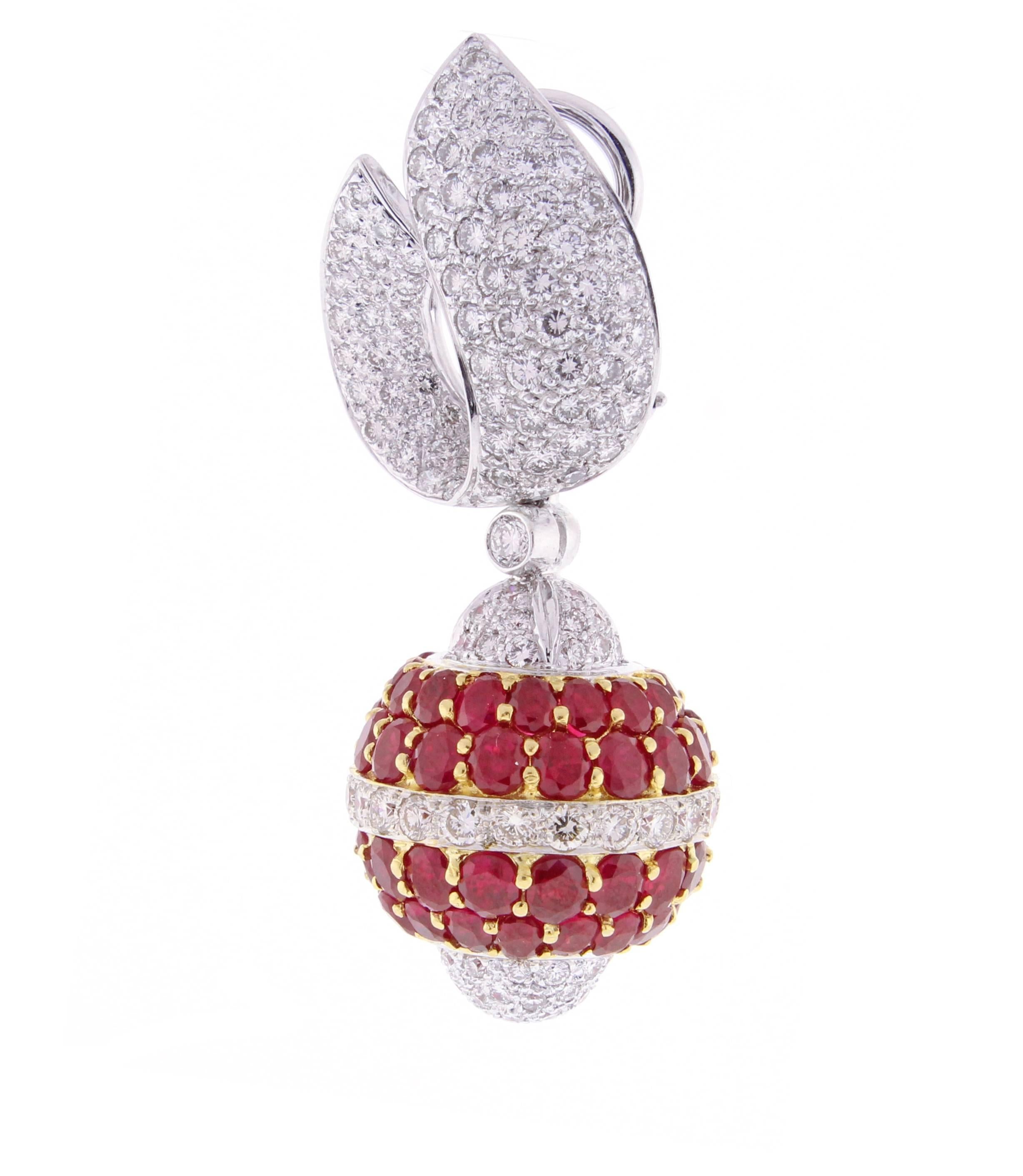 Highly important pair of ruby and pave′ set diamond earrings.  The earrings feature an ornamental drop of rubies and diamonds. The drop measures 3/4 of an inch wide and an inch high.  The overall height of the earrings is two inches. 314 brilliant