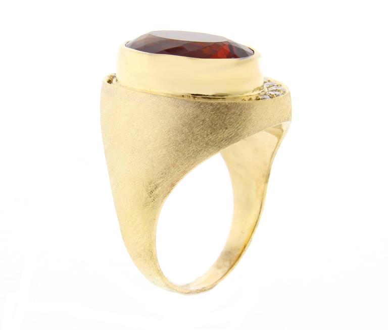 At citrine and diamond ring by world renowned Brazilian jeweler Haroldo Burle Marx (1911-1991). The ring features a  bezel set  16*10mm oval citrine and 13 diamonds weighing approximately .35 carats, set in a brushed 18 karat gold setting. Size 8