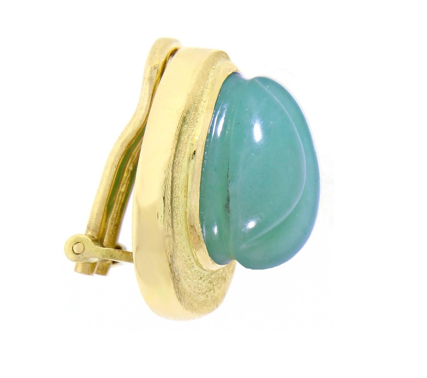 Brushed 18 karat yellow gold earrings by Burle Marx  featuring  intricately carved chrysoprase in the “forma livre” (free form) style. Roberto and Haroldo Burle Marx were particularly known for their use of large gemstones, often fashioned by