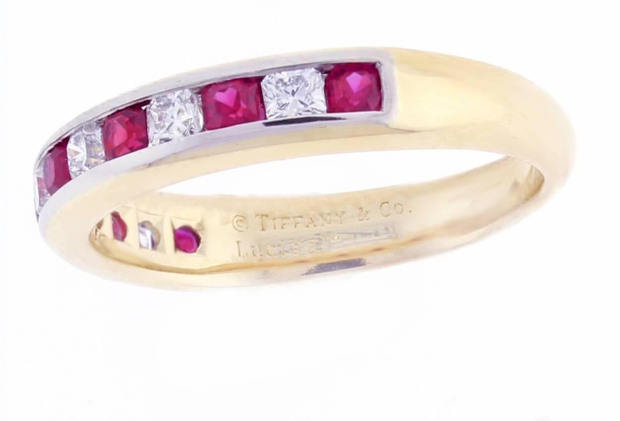 From Tiffany & Co., this 18 karat gold and platinum Lucida ruby and diamond half circle band-ring. Set with 7  Lucida cut rubies weighing approximately .49 carats and 6 Lucida cut diamonds weighing approximately .30 carats.  Diamonds F color, VVS.