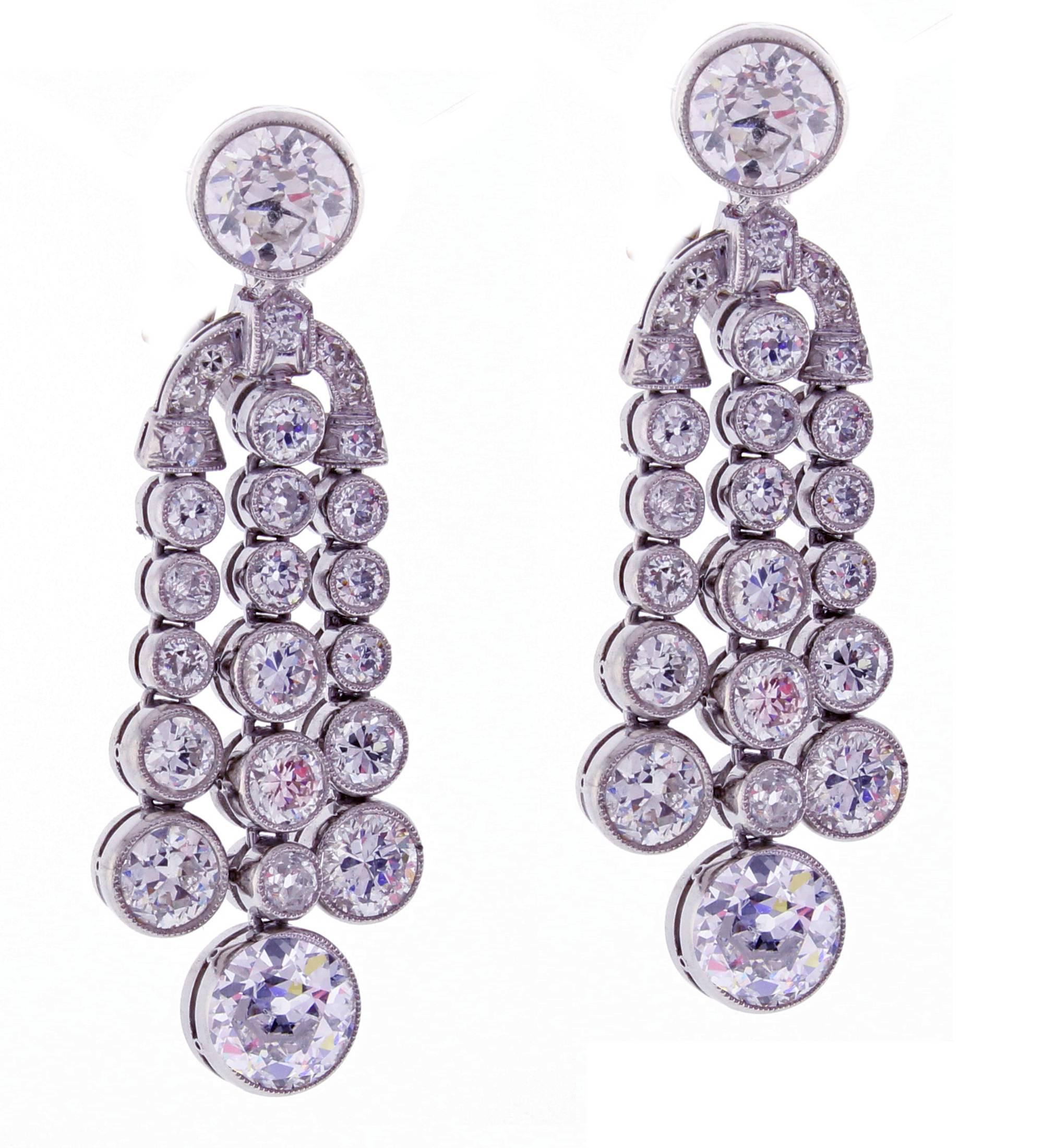 An elegant pair of  6.25 carat diamond chandelier earrings. The earrings are comprised of 4 old European cut diamonds weighing approximately  3.60 carats and 46 old European cut diamonds weighing approximately  2.65 carats. The diamonds are G-H