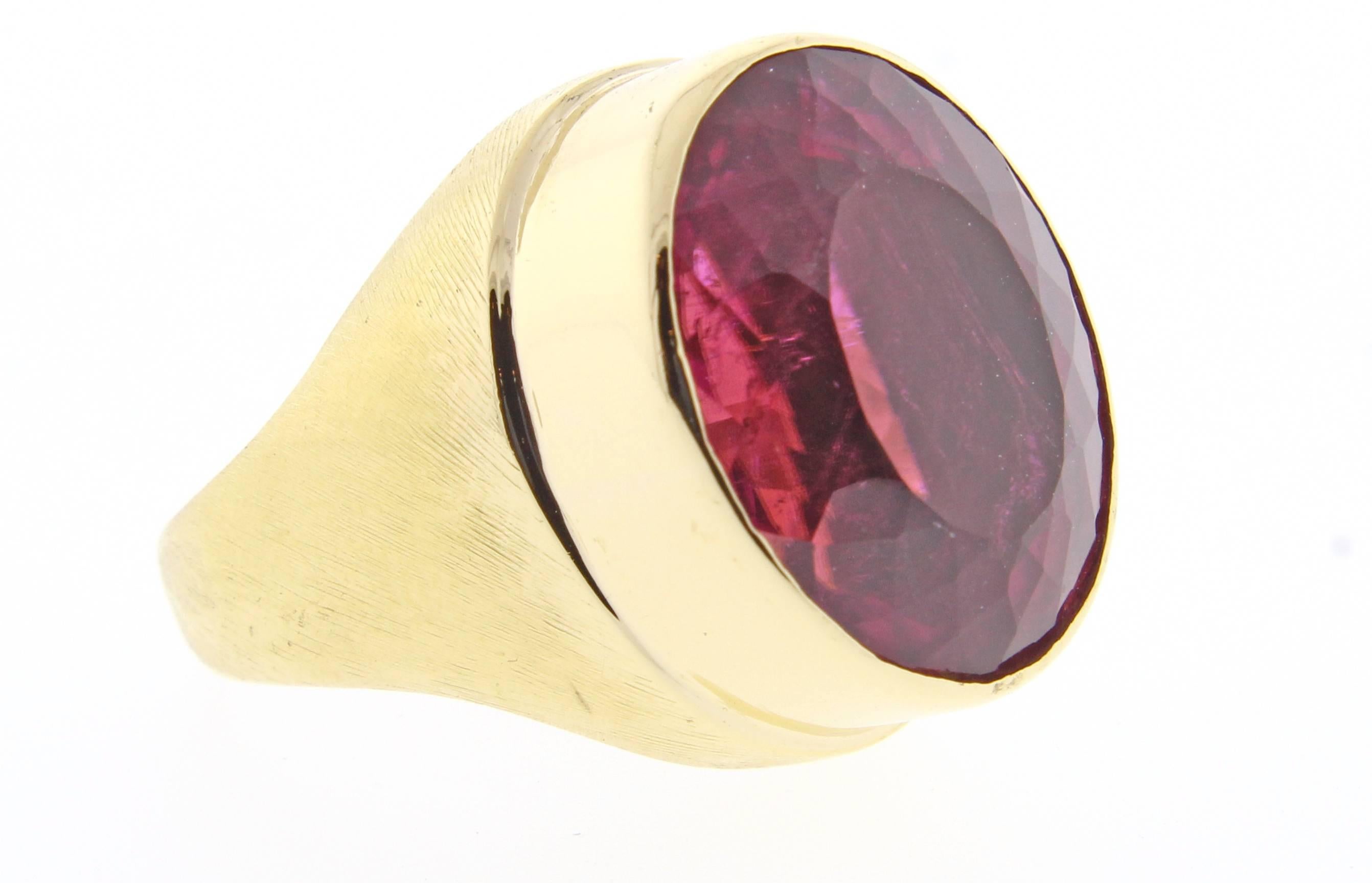 A very special large oval pink tourmaline ring by world renowned Brazilian jeweler Haroldo Burle Marx. The bezel set pink -red tourmaline measures 17*12mm weighing 17 carats and is  bezel set in a brushed 18 karat setting. Signed Burle-Marx. Size 7.5