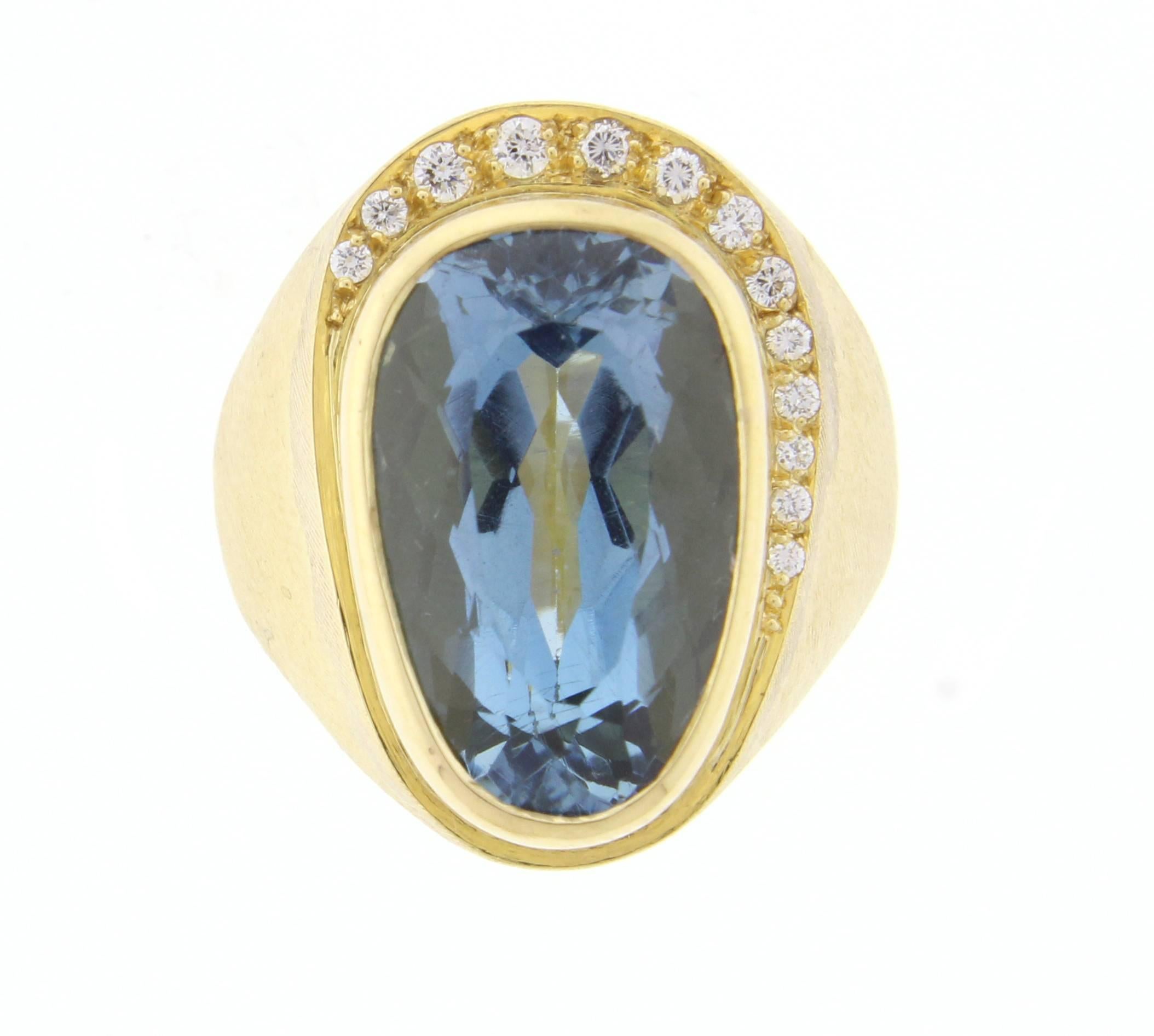 Blue topaz and diamond ring by world renowned Brazilian jeweler Haroldo Burle Marx (1911-1991). The ring features a bezel 17*11mm free form blue toaz and 13 diamonds weighing approximately .20 carats set in a brushed 18 karat gold setting. Size 6