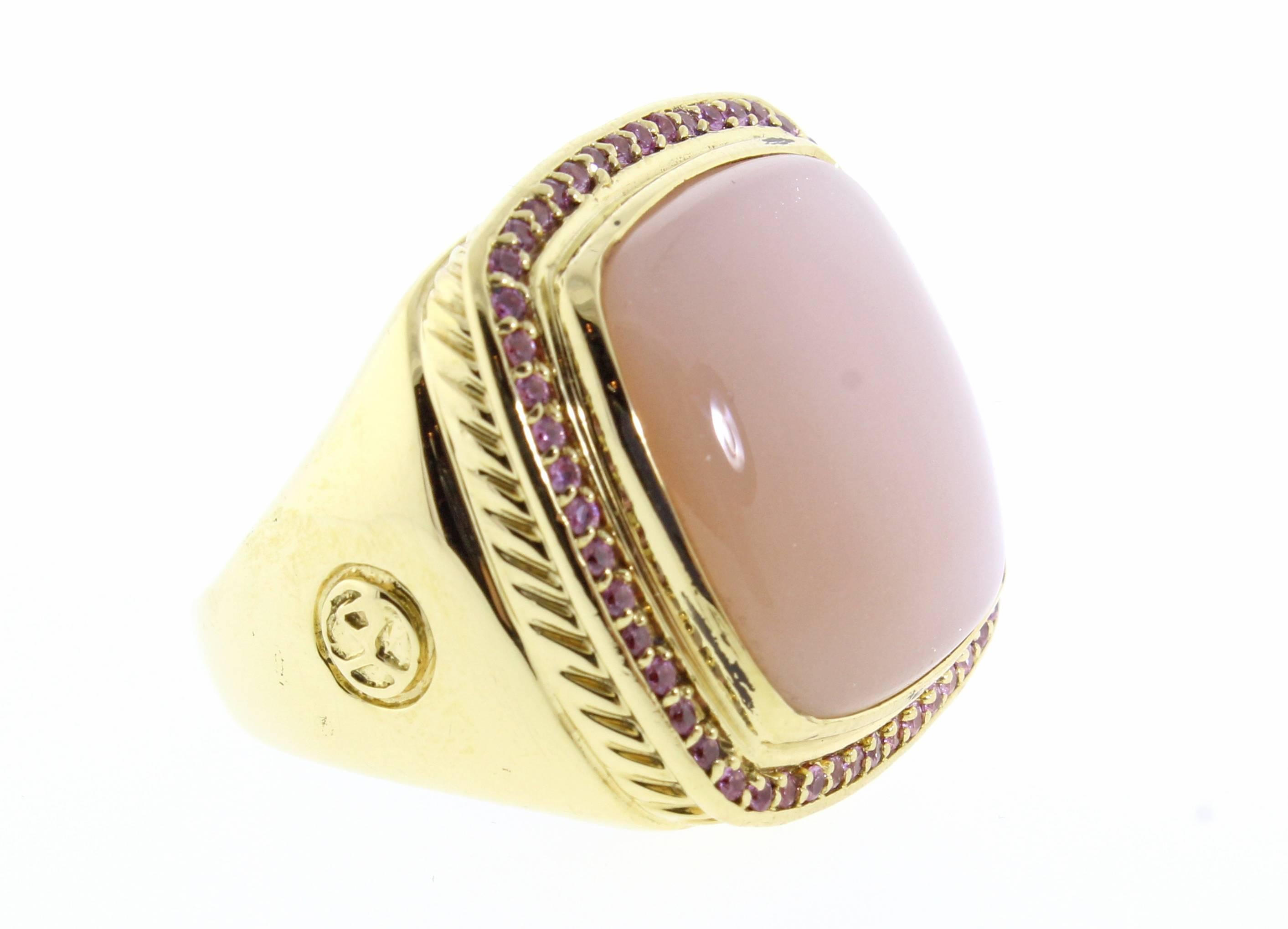 Fronm David Yurman's couture collection this large pink moonstone and pink sapphire ring. The 18 karat  yellow gold ring measures one inch square inch with vivid pink sapphires framing a dreamy pink moonstone. Size 9 