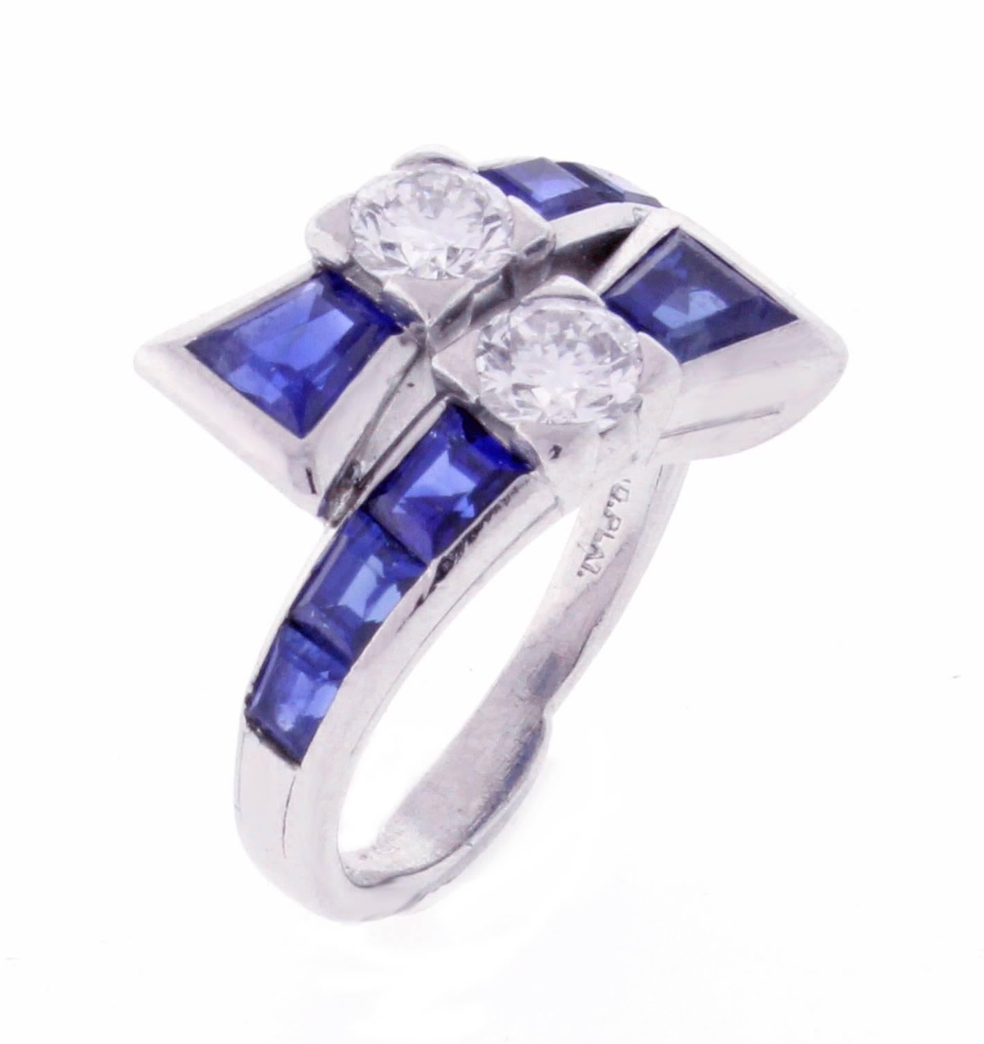 From Tiffany & Co, an unusual twin diamond and sapphire ring. The two round diamonds weigh approximately .60 carats with 8 fancy cut sapphires weighing 1.50 carats. Set in platinum,  