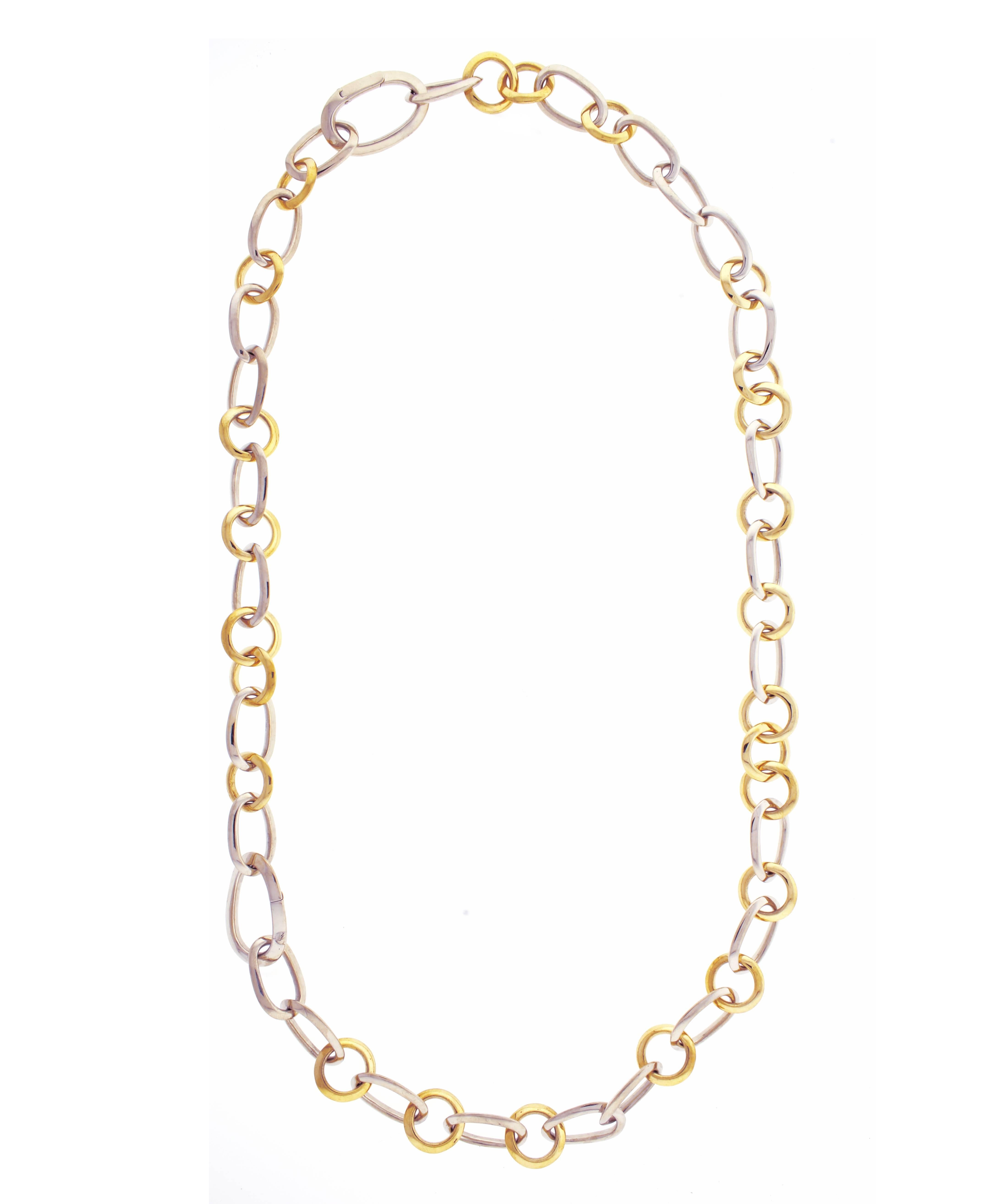Pomellato yellow and white 18 karat gold link necklace, composed of oval-shaped knife-edge style links in 18 karat white gold and circular-shaped knife-edge style links in 18 karat yellow gold, with matching bracelet, the bracelet can be attached to