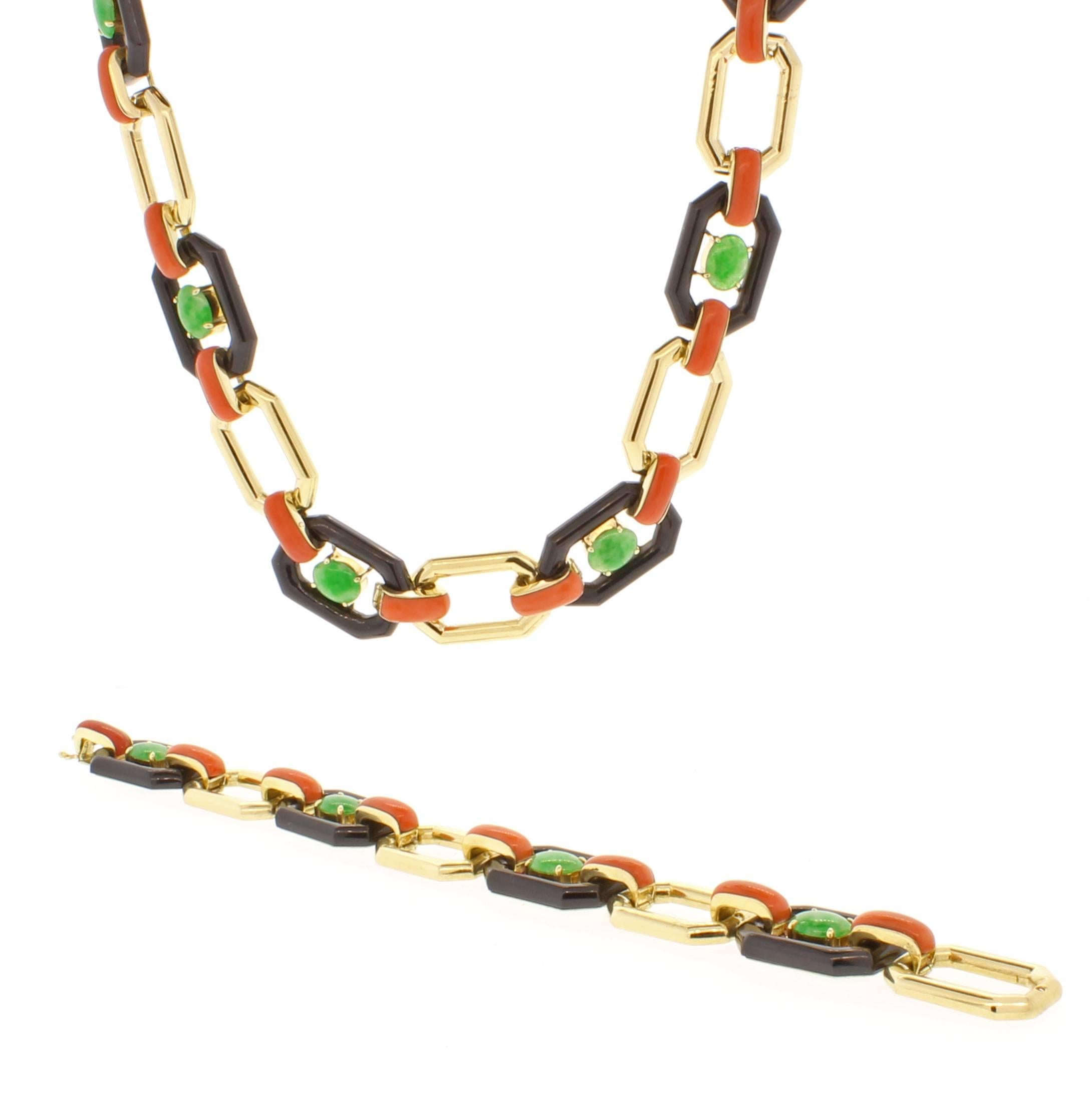 This captivating necklace exemplifies the Art Deco color palette. Oval jade cabochons are framed by black onyx links and joined with coral to open 14 karat gold links. 1/2 of an inch wide and 28 inches long. Separates to a 20 1/2 inch necklace and 