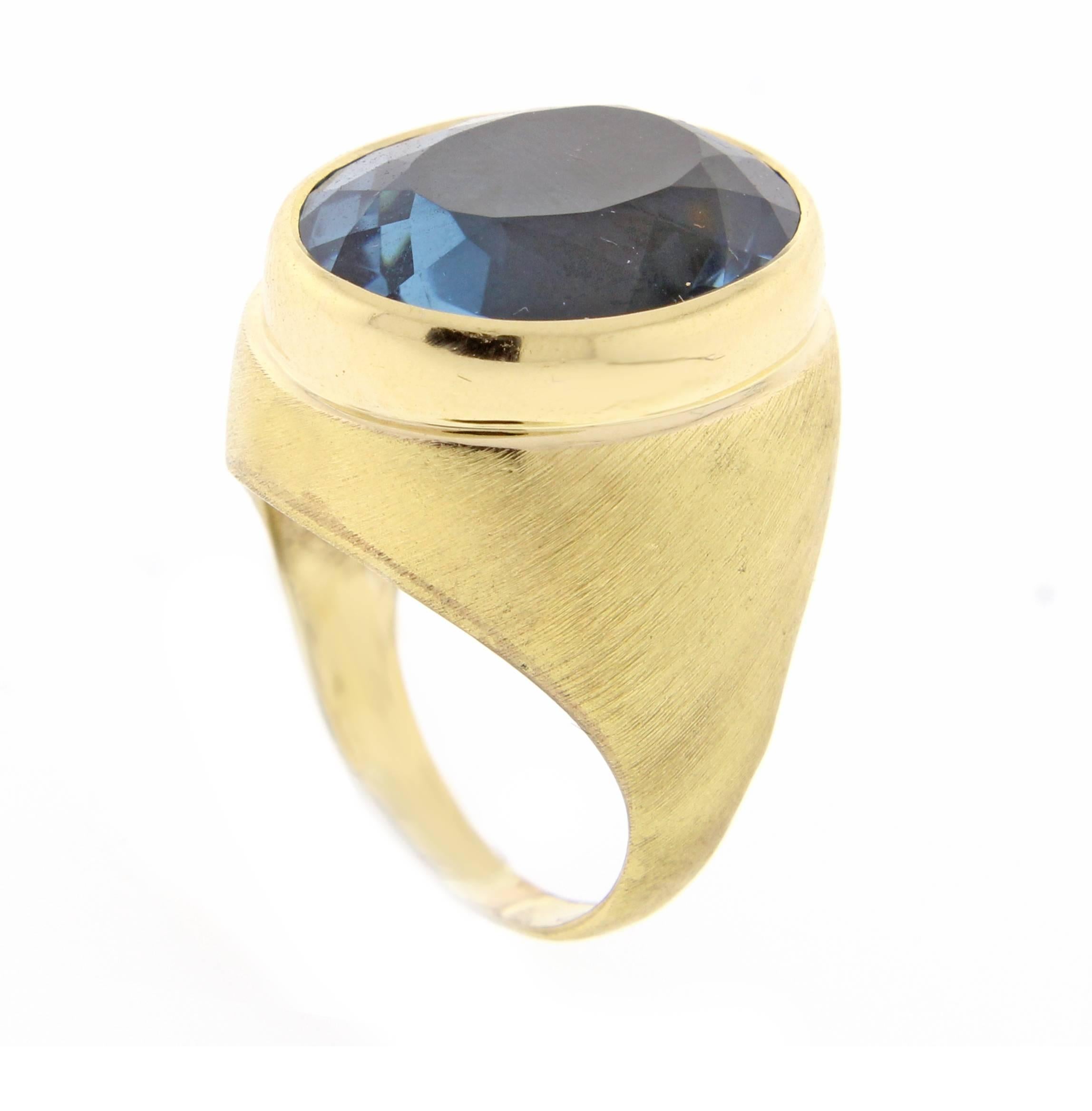 Impressive oval blue topaz ring by renowned Brazilian jeweler Haroldo Burle Marx (1911-1991). The ring features a bezel 18*14.5mm oval rich blue topaz weighing 17 carats set in a brushed 18 karat gold setting. Size 6 adjustable