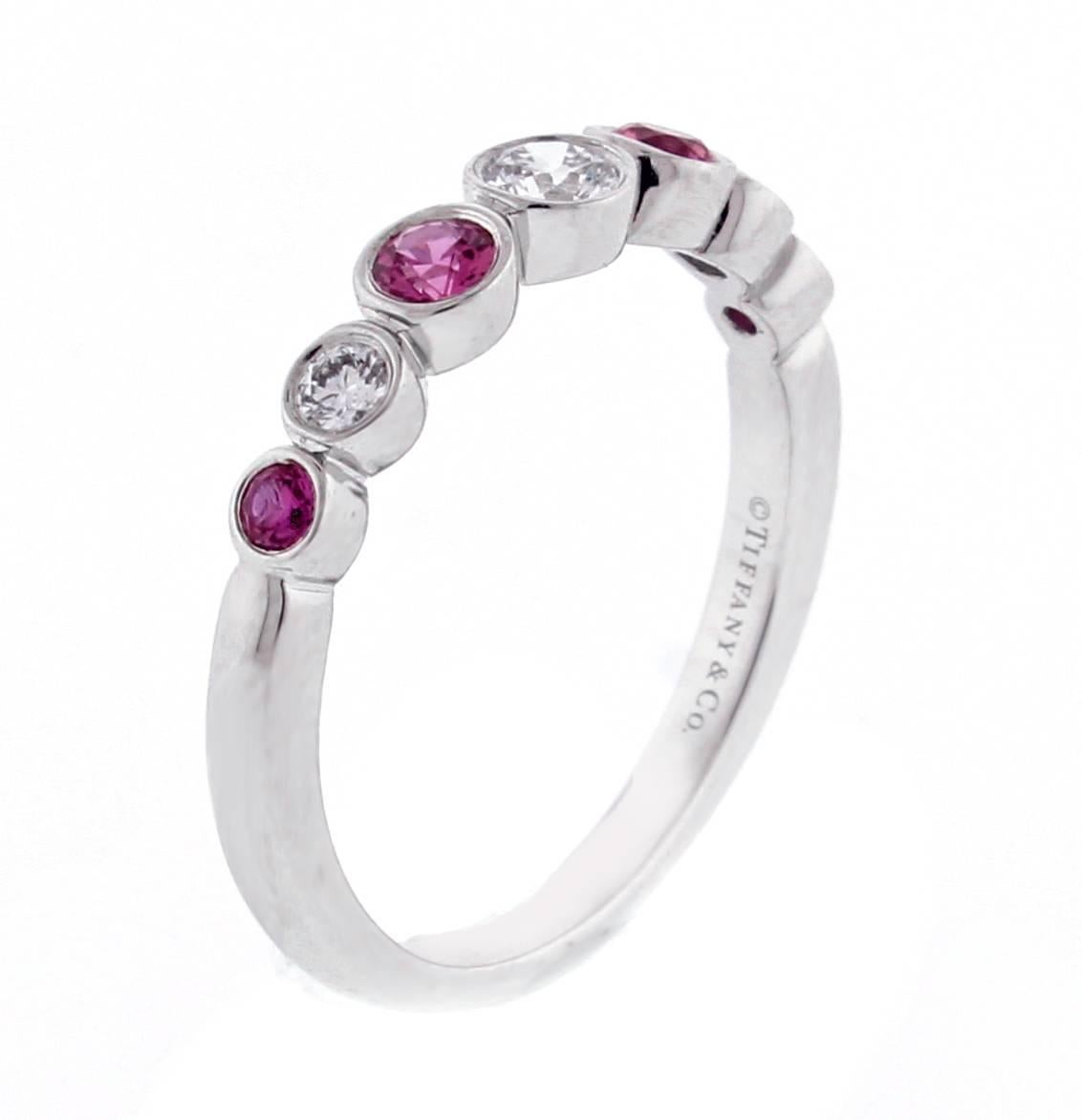 From Tiffany and Co.'s Jazz  collection, a pink sapphire and diamond Jazz ring. The  platinum ring consists of three brilliant diamonds weighing  approximately .35 carats and 4 pink sapphires weighing .40 carats, size 5.5, adjustable. This is a new