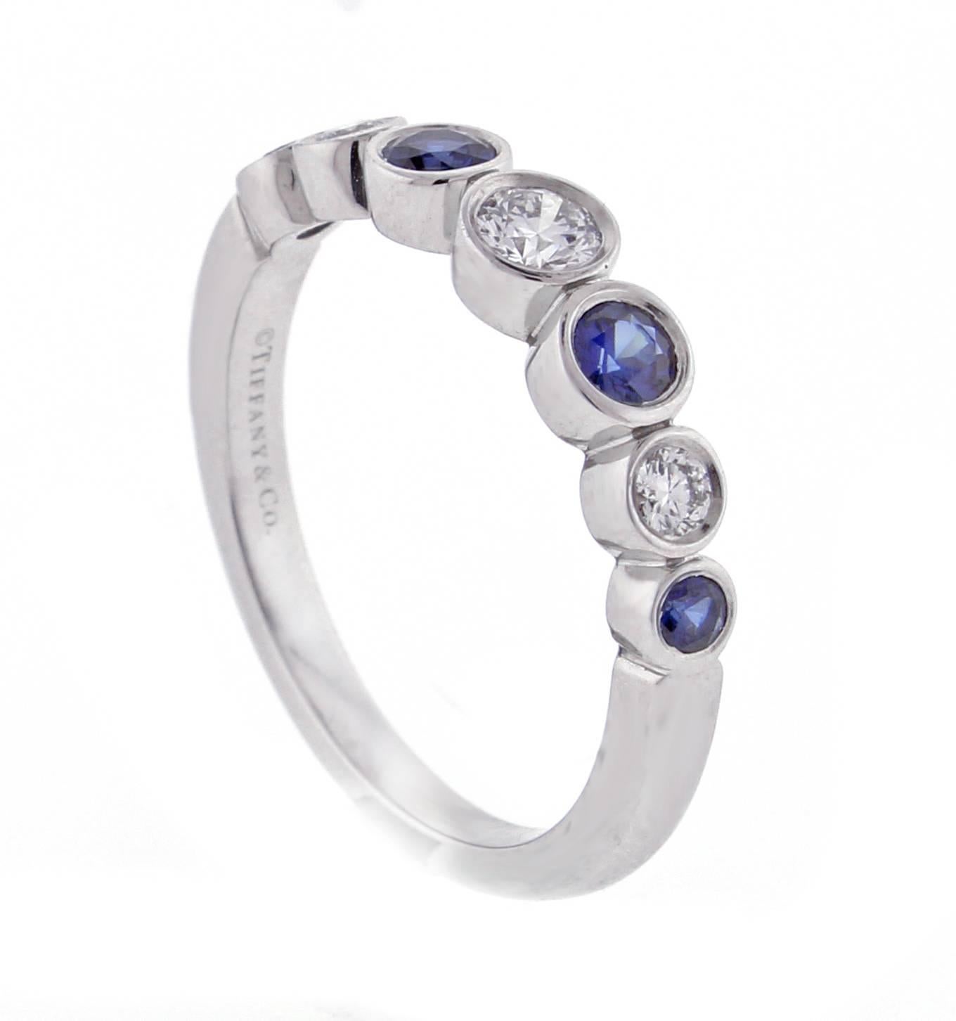 From Tiffany and Co.'s Jazz  collection, a sapphire and diamond Jazz ring. The  platinum ring consists of three brilliant diamonds weighing  approximately .35 carats and 4 rich blue sapphires weighing .40 carats, size 5.5, adjustable. This is a new