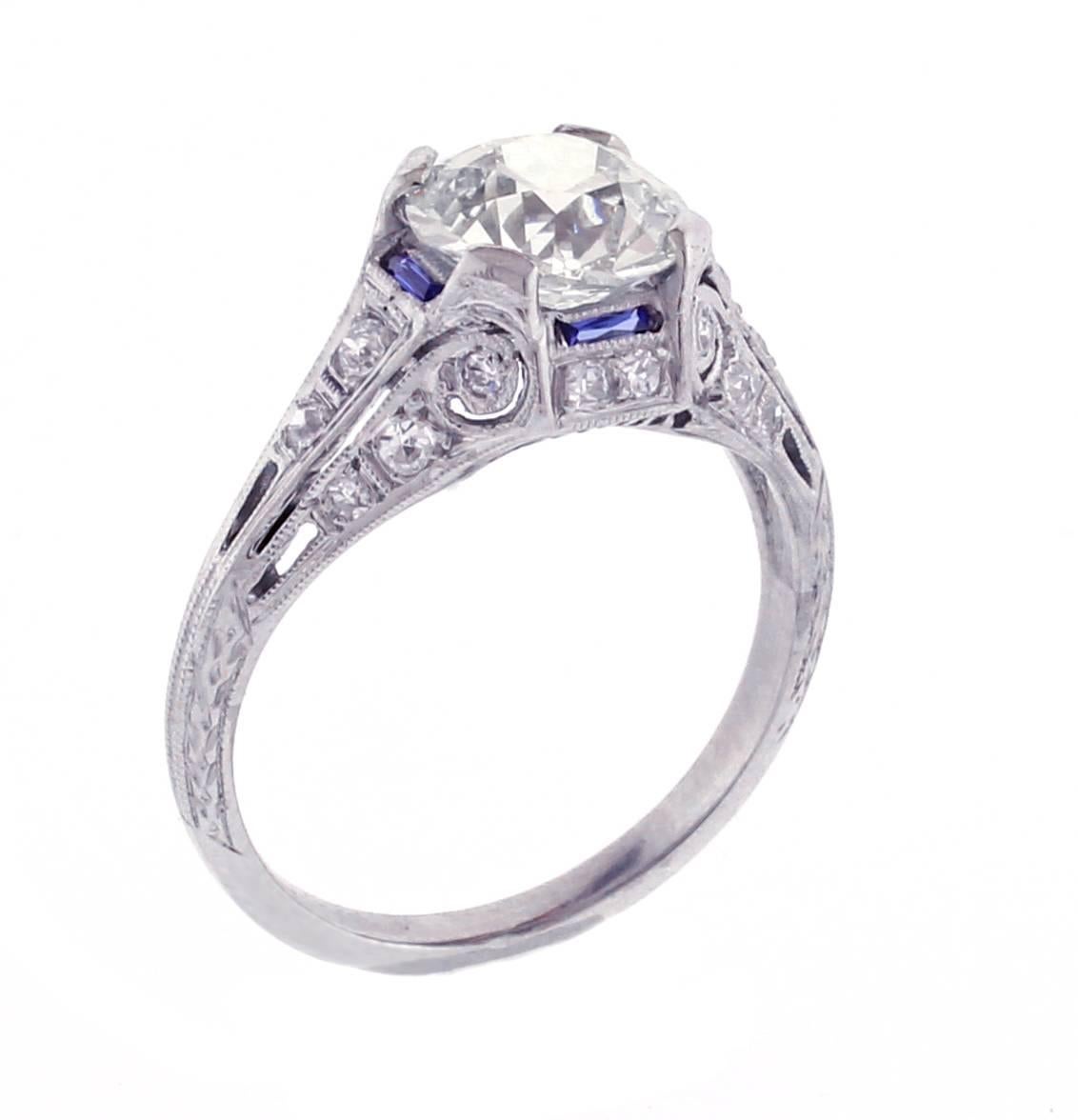 Neoclassical design motifs distinguishes this refined Art Deco  diamond engagement ring. Hand-fabricated in platinum with hand-pierced and engraved details - circa 1920s-30s. Featuring a gorgeous brilliant European-cut diamond, weighing 1.97 carats,