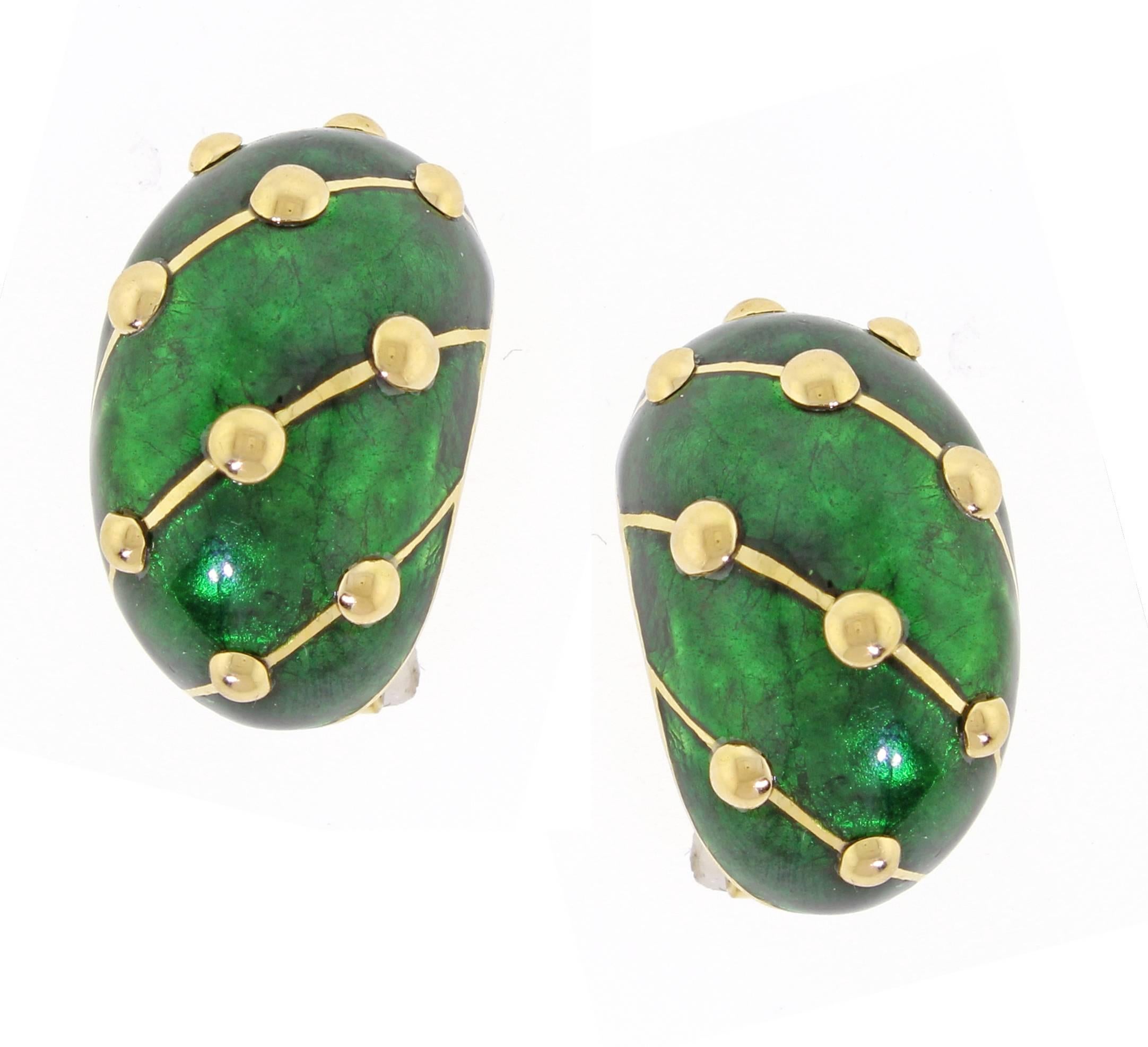 A pair of 18 karat yellow gold and deep green Paillonne enamel earclips by Jean Schlumberger for Tiffany & Co., designed as  half hoops with applied with deep green paillonne enamel accented by polished gold studs and bands.
The Paillonné technique