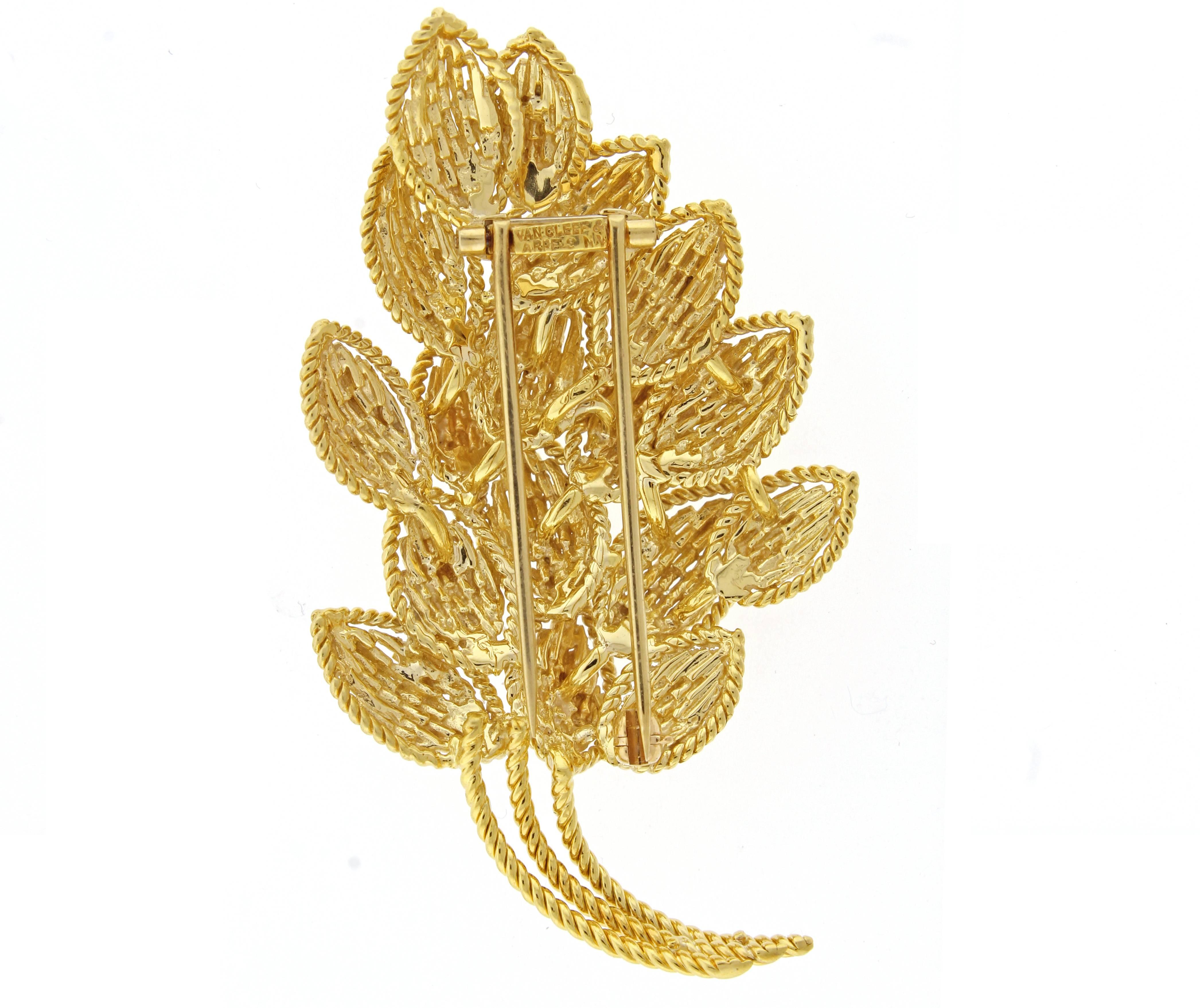 From Van Cleef & Arpels a classic tailored gold leaf Brooch.   The brooch measures  2.25 of an inch high and 1 3/8 of an inch wide 