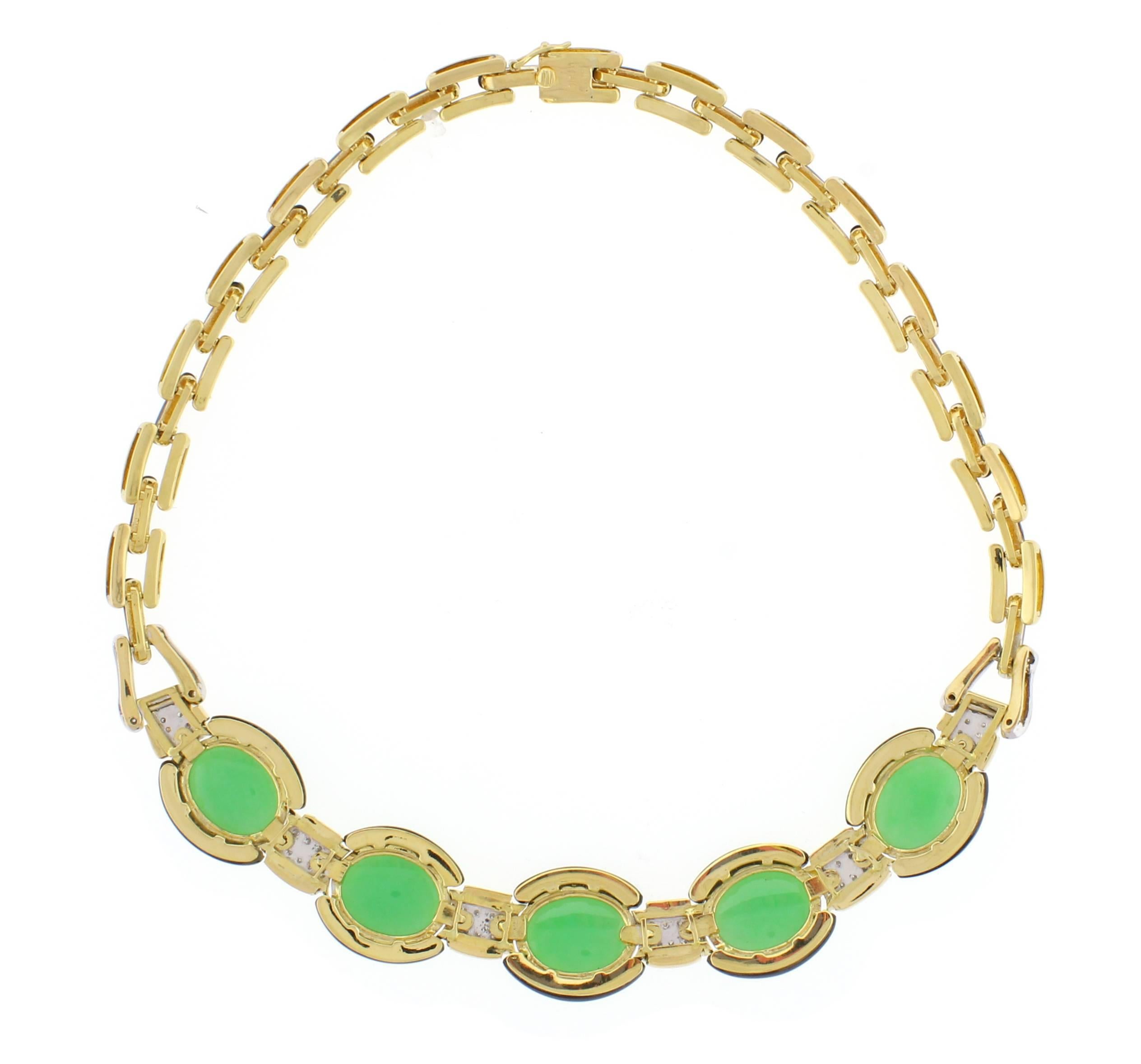 Set in 18 karat yellow gold this stunning necklace features carved black onyx sections, apple green jade cabochons and 88 shimmering brilliant cut diamonds weighing approximately 1.75. The necklace  measure one inch at its widest point and 1/2 of an