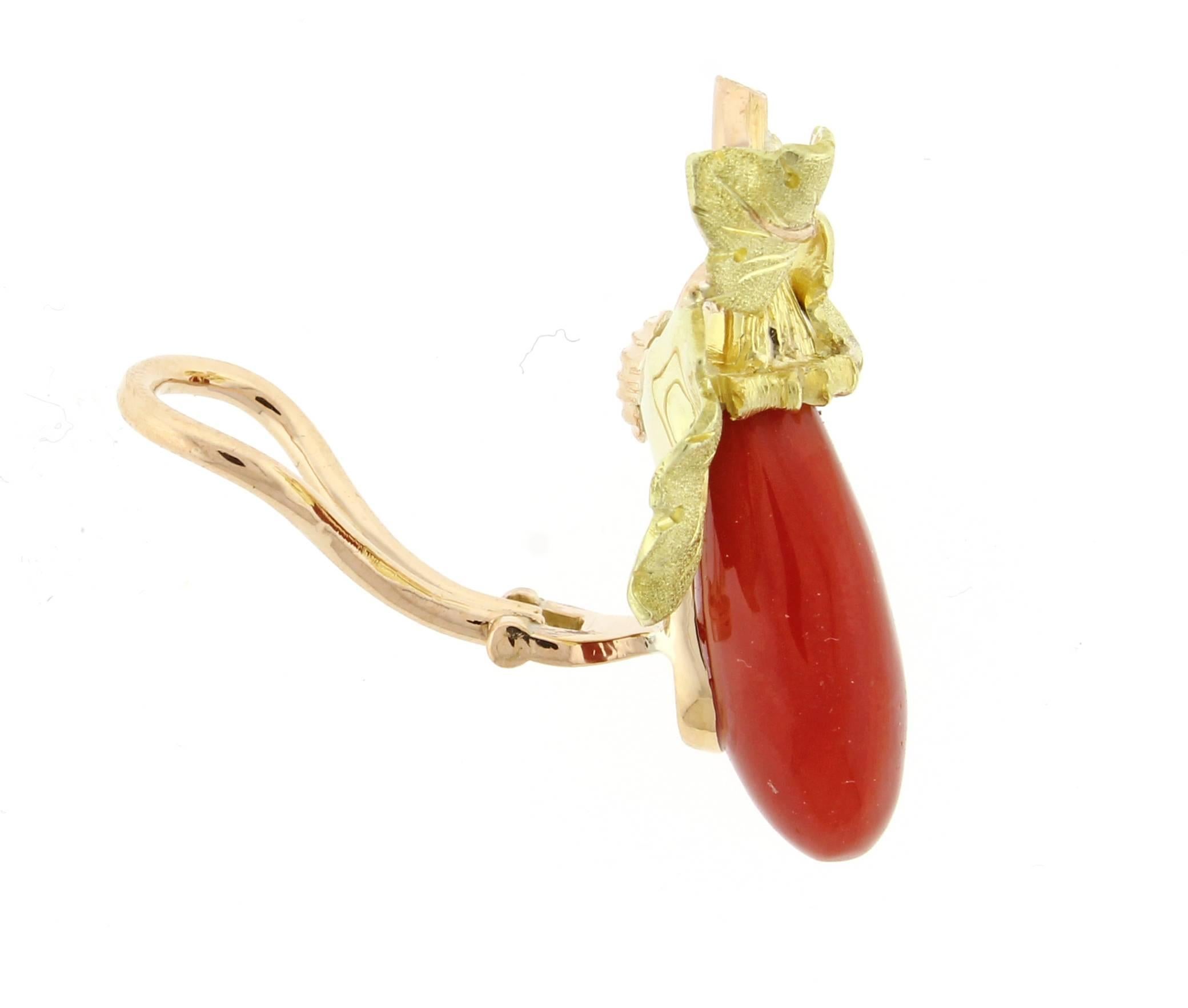 From Buccellati a  rare pair of  ox-blood coral oak leaf earrings. Three hand engraved 18 karat yellow gold leaves with pink gold veins form the earring's top that supports  the cabochon coral drops. The ox blood coral drops measure 18*9.5*6mm. The