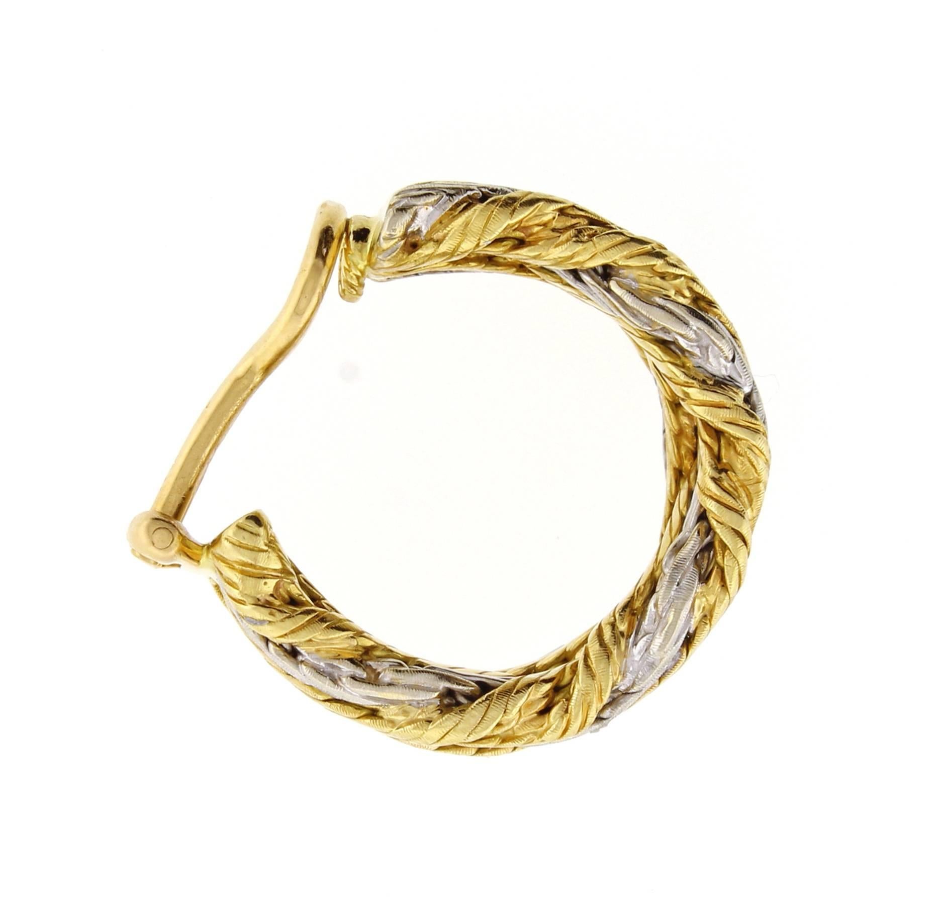 From Buccellati, a pair of white and yellow 18 karat gold braided earrings. The earrings are 3/8 of an inch wide and 7/8 of and in high.15.4 grams