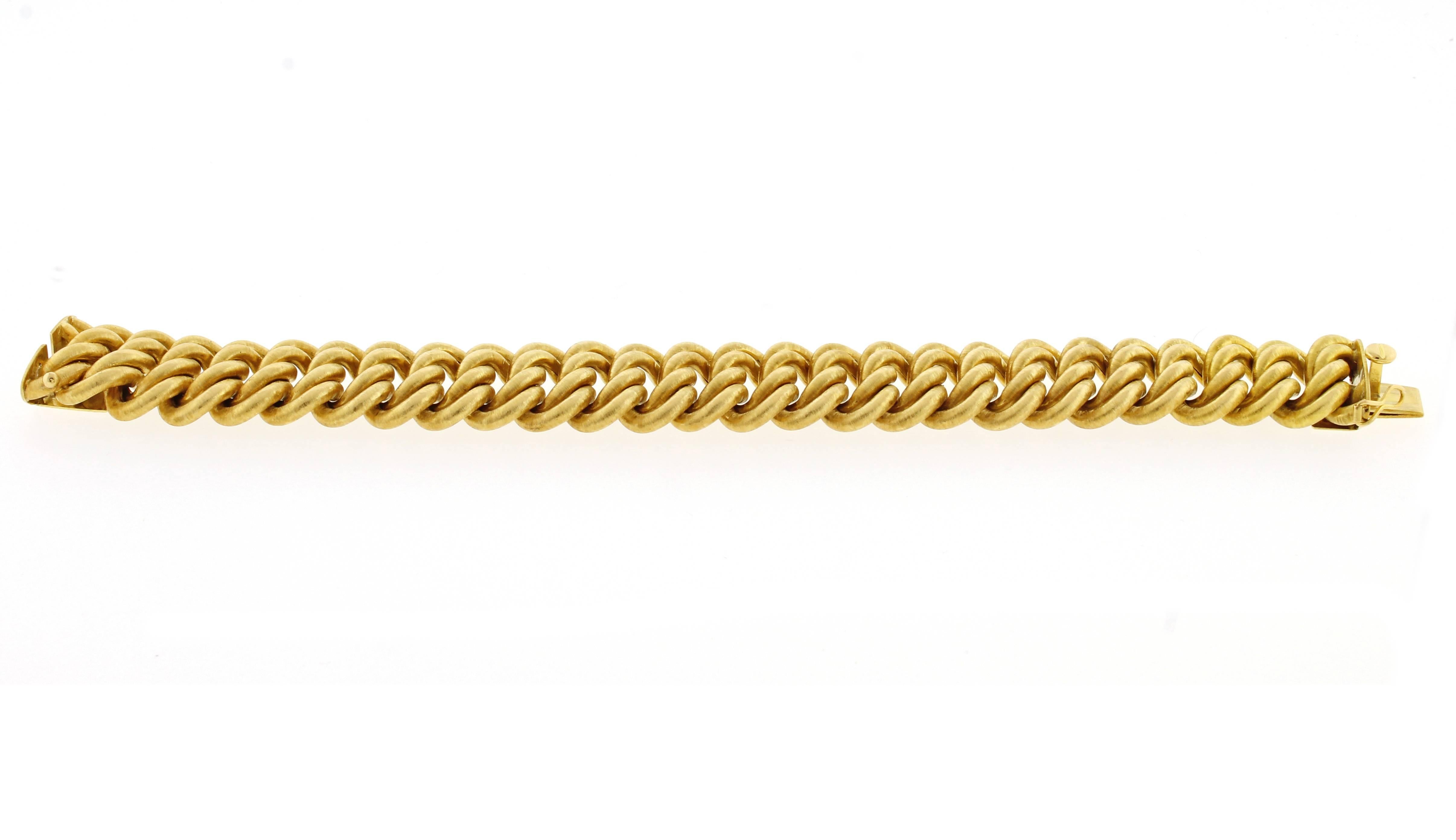 From Buccellati, a wide (7/8 of an inch) double link 18 karat gold bracelet. The soft oft matte finish typifies the craftsmanship and art of Buccellati. 8 inches. maybe shortened, 61.5 grams