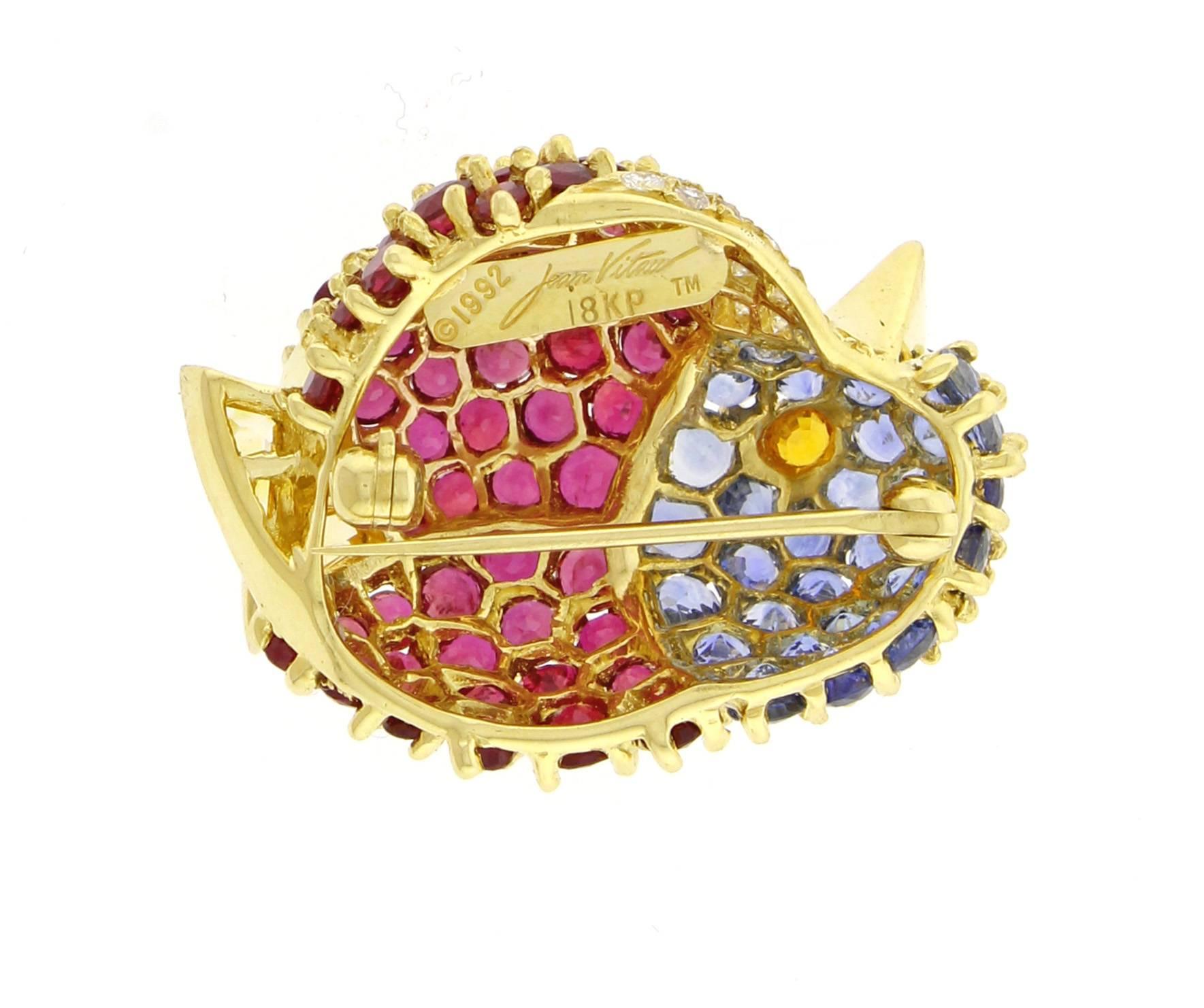 From acclaimed designer Jean Vitau, this wonderful gem-set chickadee brooch.
The brooch features rubies, sapphires and 11 diamonds set in 18 karat gold. 1 1/8 of an inch high 7/8 of an inch wide. 

 Jean Vitau is considered a pioneer in jewelry